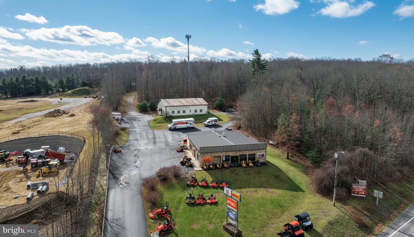 Prime Commercial Location at Deep Creek Lake! A rare opportunity positioned at the high-visibility corner of Rt. 219 & Glendale Road—one of the most traveled intersections in the Deep Creek Lake market. This property features two commercial buildings, 81'x50' & 64'x50'  both currently leased  providing immediate rental income and stability. Additional income from Cellular Tower Lease and Billboard.  Situated on 6.6 acres zoned TC – Town Center, the site allows for a wide array of approved commercial uses including restaurant, motel/hotel, convenience store/gas station, retail, and more. With valuable State Highway access, this location delivers exceptional visibility, traffic flow, and commercial potential. Ample acreage allows for future expansion or redevelopment, making this an ideal investment for both current income and long-term growth.Excellent commercial exposure and endless possibilities at Deep Creek Lake’s core business hub!