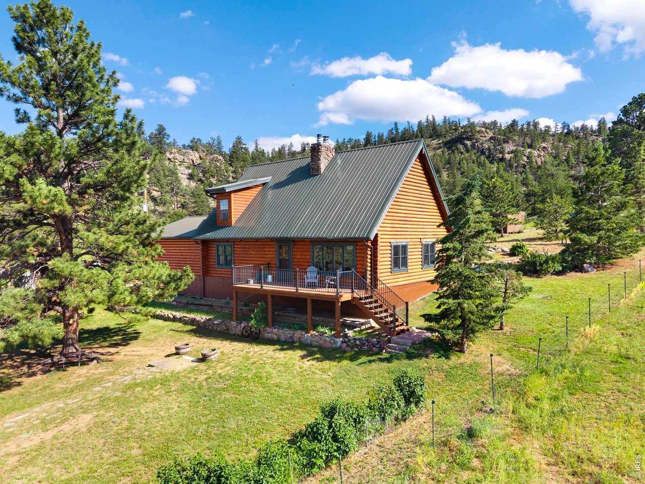 This stunning 3 bedroom log home is nestled on 35 acres of beautiful land, offering breathtaking views and endless possibilities. Featuring rustic charm and modern amenities. Part of the basement can be finished for more living space. Outside, you'll find two large metal outbuildings - one 27X43 and another 27x48 - ideal for hay storage, a small business, or workshop space. The property also boasts a deluxe chicken coop (the Ritz-Carlton of coops!), a two-stall horse barn that can store 8 large bales of hay, a fenced corral, and ample pasture where horses can roam freely. Rabbit Creek runs thru the property and the front pasture grows hay that can be cut. Additional features include a 5th wheel RV setup, fully connected to septic, water, and power - perfect for guests or for comfortable living while remodeling the main house. This is a one-of-a-kind opportunity to own a versatile property with space, beauty, and functionality. Schedule your showing today!