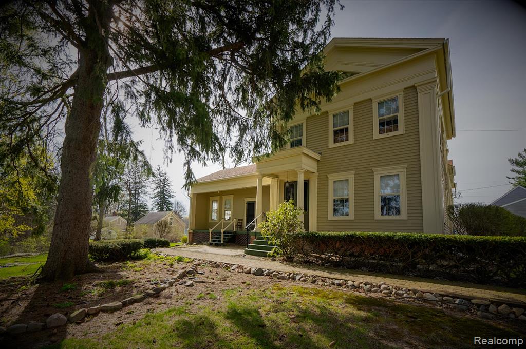 This stunning 1860s Greek Revival home masterfully blends historic charm with modern comfort. Set proudly on a tree-lined street, the residence showcases iconic architectural details, including a grand columned portico, tall windows, Gasolier Lighting and intricate moldings that speak to its storied past. Inside, soaring ceilings, hardwood floors, and hand-carved fireplaces create an atmosphere of timeless elegance, while thoughtful updates to the kitchen and baths provide effortless contemporary living. Perfectly suited for history enthusiasts and design lovers alike, this rare gem offers a unique opportunity to own a piece of 19th-century craftsmanship in an inviting, livable space. Step back in time without sacrificing modern comfort in this beautifully restored 1860s Greek Revival home, located in the heart of the Village of Romeo. This historic gem offers 4 spacious bedrooms, 2.5 updated baths, and sits on an expansive, beautifully landscaped half-acre lot. The property features a rare 4-car garage, with half thoughtfully finished into a heated and cooled studio/office space, while still offering a 2-car parking area. Recent upgrades include brand-new heating, cooling, and electrical systems, ensuring peace of mind for years to come. A grand circular driveway welcomes you home, complementing the timeless charm of the classic architecture and lush surroundings. This is a unique opportunity to own a piece of Romeo’s rich history, perfectly blended with today’s conveniences.   **SALE SUBJECT TO SELLERS OBTAINING HOME OF THEIR CHOICE**