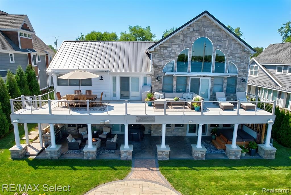 Perched along 85 feet of pristine frontage on all-sports Lake Fenton, this extraordinary waterfront residence delivers a lifestyle defined by elegance, scale, and unobstructed sunrise panoramas across glistening open water. Offering over 6,000 finished square feet of thoughtfully designed living space, including a walkout lower level, this home blends scale, comfort, and timeless lakefront appeal.The dramatic firelit great room features soaring ceilings and a striking wall of windows, perfectly framing the lake beyond. The expansive kitchen showcases granite countertops, a breakfast bar, butler’s pantry, and dining area, all opening to a 60-foot deck—ideal for effortless entertaining and everyday lake living.The luxurious primary suite is generously sized and includes a spa-inspired bath with tile and glass shower. The finished walkout lower level is an entertainer’s dream, complete with a wet bar, recreation room, firelit family room, and half bath, all flowing seamlessly to a massive stamped concrete patio with hot tub, firepit, and serene water views.Offering four bedrooms, including a spacious flex room currently used as an oversized walk-in closet that can easily be converted back to a fifth bedroom, along with three full baths and two half baths, the home provides exceptional versatility for family and guests alike. A three-car attached garage and extensive storage solutions enhance both convenience and functionality. Conveniently located near schools, shopping, dining, and US-23, this Lake Fenton home delivers both an exceptional lifestyle and an ideal commute. ALL BUYERS must have a pre-approval letter or proof of funds to schedule a showing NO EXCEPTIONS!