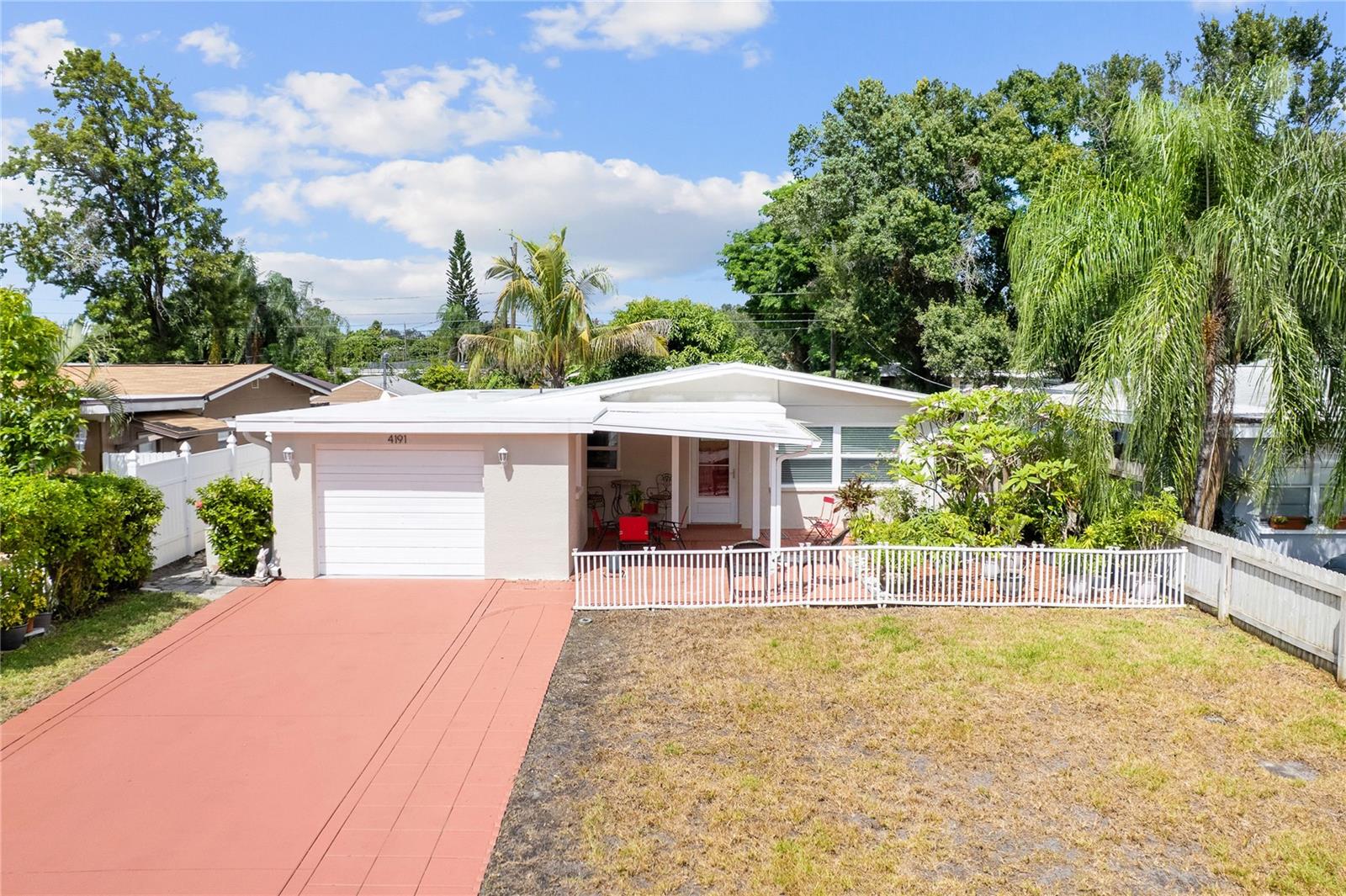 ABSOLUTELY A GEM! TURNKEY AND MOVE-IN READY — WAITING FOR YOU!This beautifully updated 4-bedroom, 2-bathroom home with a 1-car garage offers the perfect combination of comfort, style, and convenience. From the moment you arrive, you’ll notice the pride of ownership and extensive updates throughout. Major improvements include a 2024 roof, brand-new 3.5-ton A/C system, 2017 water heater, and appliances approximately four years old. The home features beautifully updated bathrooms with designer touches, new light fixtures, ceiling fans, switches, and outlets. Additional upgrades include new gutters, a new garage door motor and rollers, and a new keypad garage opener. The home has been freshly painted inside and out, from floor to ceiling, and features new baseboards throughout, along with a refreshed driveway and new landscaping in both the front and back yards.As you arrive, you’ll be welcomed by a captivating variety of tropical flowers, creating a beautiful and inviting outdoor setting. Relax and enjoy the Florida lifestyle on the covered patio.Step inside to an open floor plan featuring an updated kitchen with dazzling quartz countertops and stylish finishes. Two bedrooms are fully furnished and ready for you to enjoy a comfortable night’s sleep. The fourth bedroom offers additional privacy with double French doors and its own private screened-in lanai, making it ideal for a guest suite, home office, hobby room, or personal retreat.Step outside and enjoy the fresh air surrounded by a variety of fruit trees and another covered seating area perfect for relaxing or entertaining. One of the property's unique features is the rear access from an easement alley, providing convenient access to the fourth bedroom and additional storage possibilities, including easy access for a boat or RV.The location is just as impressive! Enjoy walkability to public transportation, shopping centers, restaurants, Parkside Mall, and a movie theater. Conveniently located approximately 20 minutes from Tampa International Airport and 14 minutes from St. Pete-Clearwater International Airport, with easy access to the beautiful Gulf beaches and so much more. With the major improvements already completed, this home offers the convenience of move-in-ready living without the worry of having to replace major items for years to come. Come see this exceptional property for yourself — you won’t want to miss it!