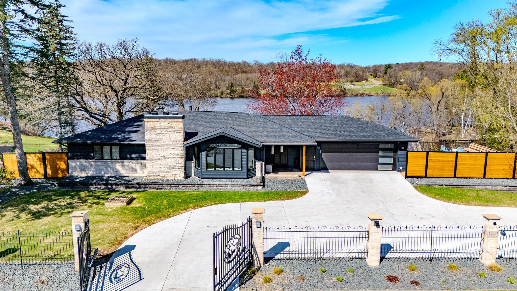 Spectacular Mississippi River home offering a rare blend of privacy, luxury, and waterfront lifestyle on approximately 3 beautifully landscaped acres just a couple miles from the heart of Little Falls. This one-of-a-kind 5 bedroom, 4 bath property features nearly 5,000 finished square feet, a secluded harbor for water toys, private boat ramp, docks, and a 56’ long/5’ wide stunning bridge leading to a private island retreat. Designed for entertaining and everyday comfort, the home has seen extensive recent updates including new flooring throughout multiple upper and lower-level living spaces, newly spray-foamed basement primary suite and living room, updated lighting, new basement gym windows, a newly concrete driveway and an upgraded garage system with new door and entry access. Outdoor living is elevated with an expansive backyard patio featuring a 78” Aura Linear Fire Pit Table, automatic Haven pathway lighting, WiFi-enabled sprinkler system and newly installed privacy fencing. Additional premium features include Ghost Control automatic driveway gates, Tesla charger, underground dog fencing, Trex decking, 43x30 insulated concrete floor Toy Shed and a circular driveway. Enjoy an incredible 9 miles boating, fishing, entertaining, and year-round Minnesota living just minutes from the golf course and Soo Line Trails in this truly exceptional Mississippi River property.