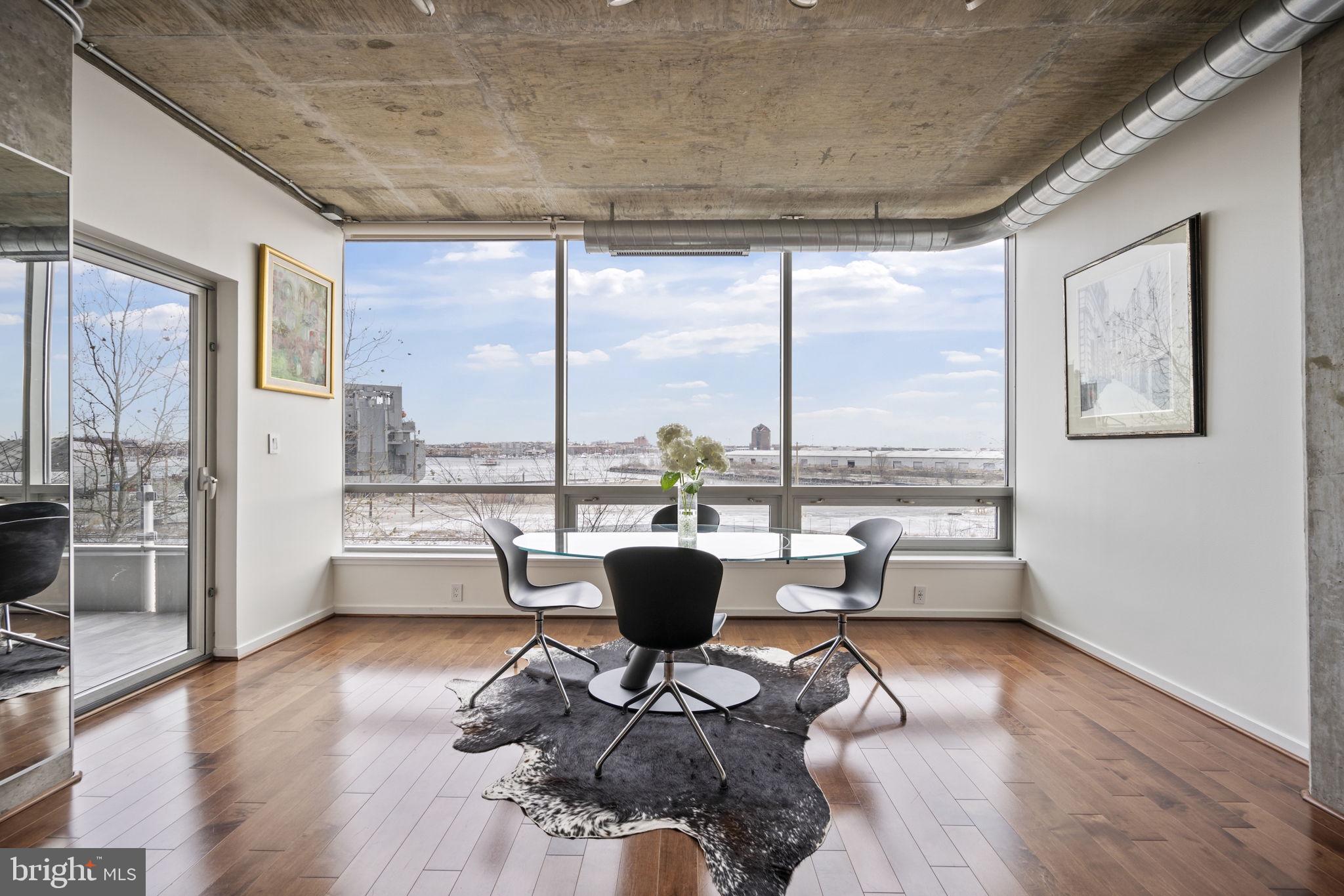 Welcome to Silo Point, where luxury meets some of the best water views in Baltimore. This spacious residence is truly move-in ready, blending modern elegance with contemporary design. The unit is 1,859 square feet with two large bedrooms and two and a half baths. From the moment you enter, the floor-to-ceiling windows with direct city and water views captivate you. Hardwood floors throughout the unit, neutral paint, custom closets, updated bathrooms and your dream kitchen await. The kitchen has been updated with new Fisher & Paykel appliances including an induction stove, premium cabinetry, soft-close-drawers, granite counters and a custom tile backsplash. The primary bedroom includes a walk-in closet with built-ins, water/city views, black-out curtains, and a luxury full bath with dual sinks and separate soaking tub. The second bedroom has its own private bath, city/water views, and an added sound barrier. Tech upgrades include speaker system, USB outlets, and motorized Lutron blinds. Watch the sunrise with your morning coffee from the private balcony with new tile floor and space for your outdoor furniture. The unit has two reserved garage parking spaces. Silo Point has an exceptional location and amenities, including 24/7 Concierge, secured parking, fully equipped fitness center with yoga studio, game room, private treatment/massage room, 19th floor Sky Lounge with panoramic harbor and city views, and designated pet area. Enjoy close proximity to Latrobe Park, restaurants, supermarket, and an ideal location for commuters with easy access to I95, 295, 395, and BWI airport.