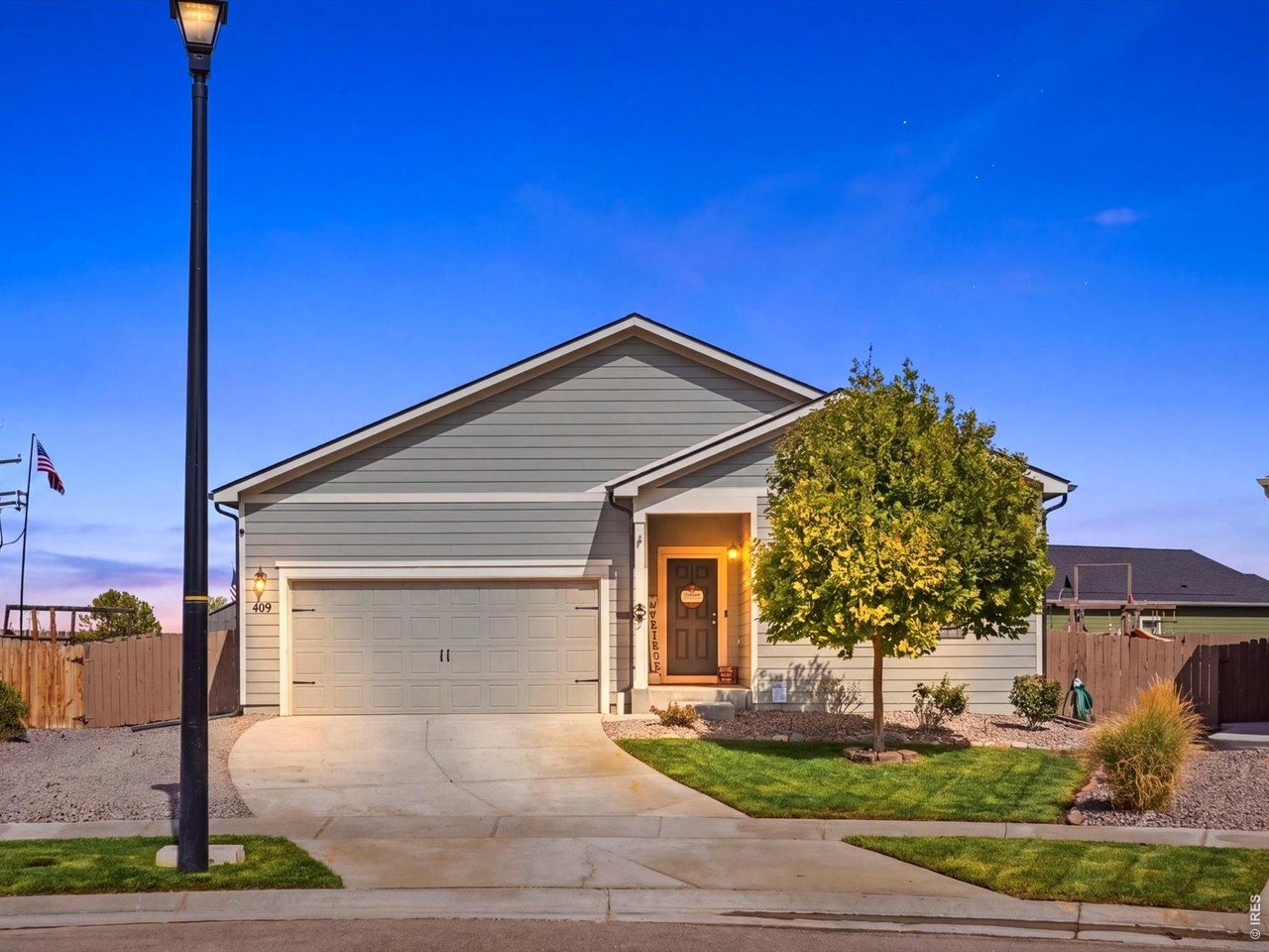 Single-level living on one of the biggest lots you'll find in Keenesburg. This home is fresh and move-in ready, with brand new carpet in every bedroom, light plank flooring through the main areas, and a brand new water heater. The open layout centers on a granite island kitchen with espresso cabinetry, stainless appliances, a gas range, a pantry, and a built-in coffee bar. A sliding glass door off the dining area brings in natural light and opens to the yard. The spacious primary suite has its own bath with a long granite vanity, walk-in shower, and large walk-in closet, while two more bedrooms share a full bath. Out back, the massive, fully fenced yard offers a green lawn, low-maintenance rock landscaping, a play area, and room for a garden, pets, and a fire pit. A two-car attached garage completes the package. Schedule your showing today.