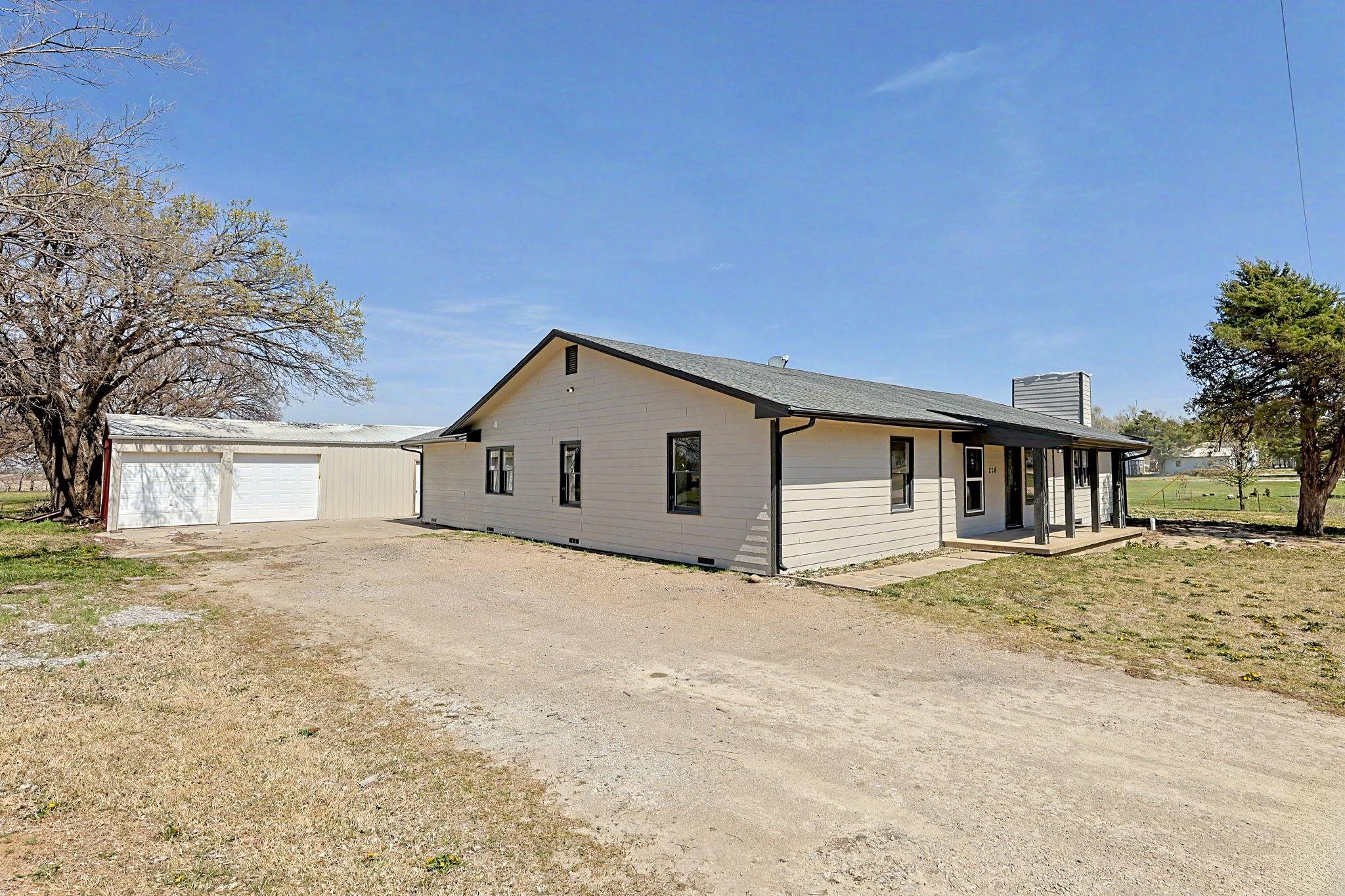 Looking for acreage just outside of Wichita?  Welcome to Your Private Oasis  located just off of K254 and Greenwich road.  Step into a world of boundless space and quiet luxury with this stunning residence, perfectly situated on an expansive 1.3-acre lot. If you’ve been dreaming of room to breathe, this property delivers an unrivaled sense of scale and freedom.  The true centerpiece of this residence is the spectacular gourmet kitchen. Designed for both the serious chef and the frequent entertainer, it features sleek, sprawling granite countertops that offer endless prep space. Brand-new appliances, complemented by an abundance of cabinetry. Whether you're hosting a holiday feast or enjoying a quiet morning coffee, this kitchen serves as a grand and inviting hub.  The floor plan is defined by its airy, open feel. Every room feels generously proportioned, boasting high ceilings and wide windows that bathe the home in natural light. The transition between living areas is seamless, creating a vast interior landscape that can easily adapt to your lifestyle—whether that means cozy family nights or large-scale social gatherings.  The 5 large bedrooms are perfect for a growing family.  The master bedroom has a brand new bathroom with dual sinks and tile shower.  The master closet is huge and has custom shelving.  Both bathrooms have been completed updated with custom tile showers.  Outdoor Freedom & The Ultimate Shop.  The interior beauty is matched only by the immense outdoor footprint. Spreading across 1.3 lush acres, the backyard is a private park ready for gardening, recreation, or simply enjoying the Kansas sunsets in total serenity.  For the hobbyist, craftsman, or collector, the massive detached shop is a game-changer. This substantial structure provides an incredible amount of versatile square footage, perfect for a home business, car restoration, or the ultimate "man cave" or "she-shed."  Experience the perfect balance of modern sophistication and wide-open spaces.  These types of properties rarely come for sale.  Hurry!!!