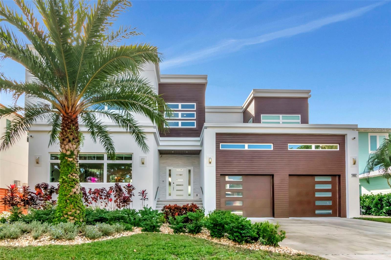 This one-of-a-kind waterfront retreat in South Tampa offers the ultimate blend of modern luxury and thoughtful accessibility. Situated on a .23-acre cul-de-sac lot, this custom 2-story all-block residence is built on pilings with impact windows and doors for peace of mind.Step inside to an airy, open floor plan illuminated by natural light and anchored by a specially curated Illuminati Glass chandelier featuring 89 hand-blown pieces. The chef’s kitchen is a masterpiece of Custom Italian Cabinetry, sleek quartz countertops, and professional-grade Wolf and Sub-Zero appliances.The home’s 6,386 sq. ft. includes 5 bedrooms and 5.5 baths, where every bedroom is oversized, ensuite, and features a walk-in closet. Designed for longevity, the second floor and elevator entry from the garage make the home ADA-compliant ready. Sound-reduction insulation in the floors and walls ensures tranquility throughout.The second floor hosts a spacious family room, a dedicated office, and four large bedrooms—including a primary suite with sweeping bay views, a spa-like bath, and a massive walk-in closet. For even grander views, the roof is structurally ready for a custom flat deck to overlook the open bay.Outside, the Ryan Hughes-designed pool serves as a breathtaking courtyard centerpiece, featuring a sunken fire lounge, linear flame features, and a luxury outdoor kitchen under shaded pavilions. Plus, enjoy the benefits of solar energy in this high-tech, high-design masterpiece. Located on a wide canal just four lots from the open bay, this home is minutes from International Plaza and the Tampa International Airport.