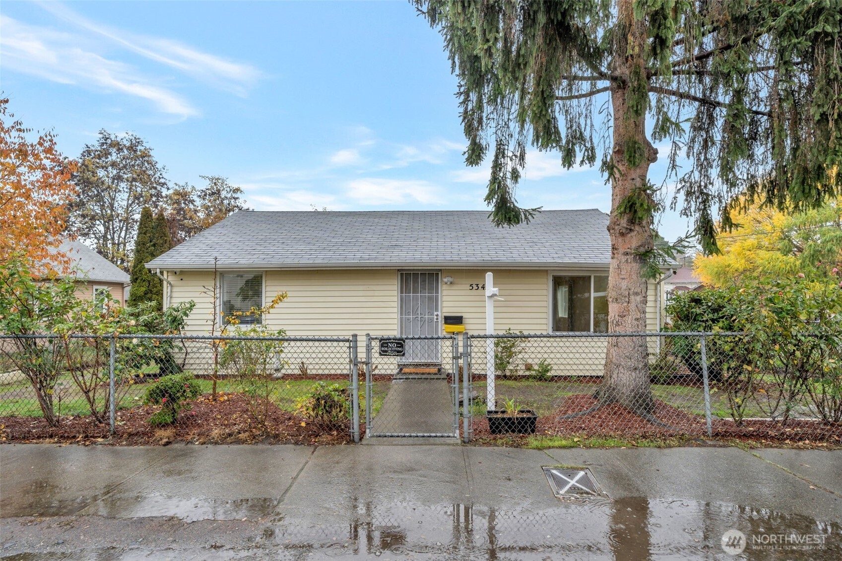 This home is cozy and private, filled with natural light. The spacious kitchen features ample cabinetry and counter space, making it ideal for everyday living. Enjoy a large living room, two comfortable bedrooms, and a stylish bathroom equipped with a smart toilet heated seat.    The fully fenced yard is beautifully landscaped, perfect for gardening, playing, or simply relaxing on the spacious deck and soaking up the sunshine. Additional amenities include a large corner lot, ample off-street parking, and a storage shed. Conveniently located just minutes from Kent Station, which offers dining, shopping, and entertainment. This home also comes with packages for air sealing, flooring & attic insulation, and a brand-new gas furnace.