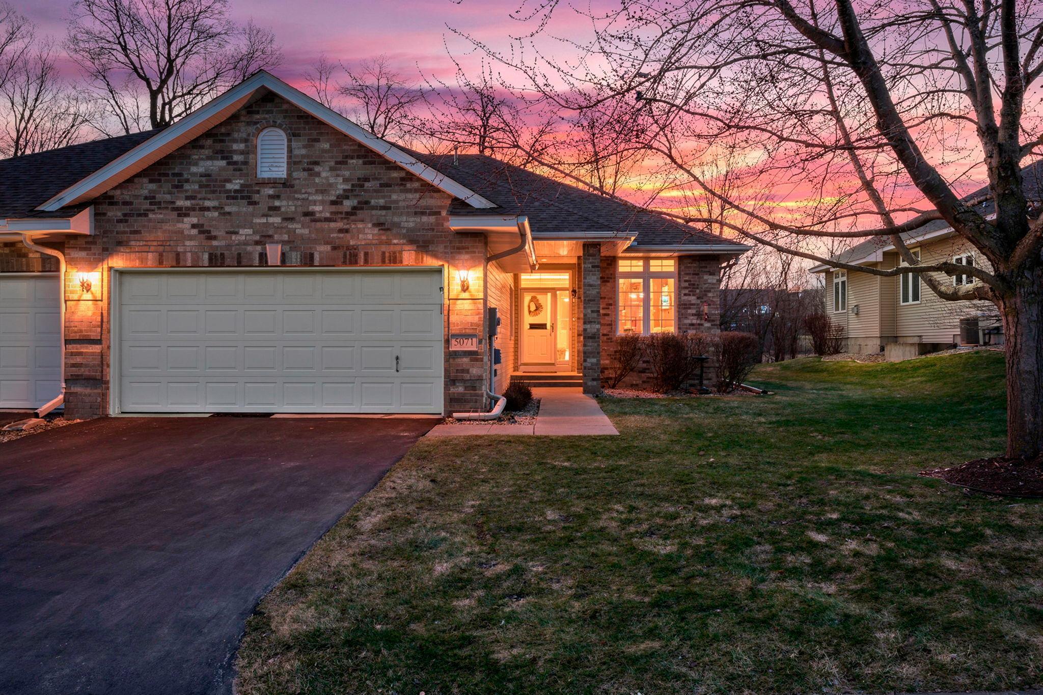 Discover this amazing & spacious end-unit townhome tucked in a serene cul-de-sac, offering privacy, natural beauty, and easy access to community walking trails. The sun-filled main floor features 10-foot ceilings and an open, inviting layout. The kitchen offers abundant cabinetry, generous counter space, a center island, hardwood floors, and a cozy eat-in dinette. The family room is warm and welcoming with its gas fireplace, seamlessly connecting to the formal dining area and the bright sunroom, which walks out to the private back deck—perfect for morning coffee or evening relaxation. The main-floor primary suite boasts oversized windows, a walk-in closet, and a full bathroom with a soaking tub. An additional main-floor office doubles as a bedroom, and the convenient laundry room is located near the 3/4 bath. The finished lower level expands your living space with a large family room, an additional bedroom and 3/4 bath, plus abundant storage and the potential for a future fourth bedroom. Fresh paint throughout and brand-new carpet on the main level make this home truly turnkey. Wildlife sightings—deer, birds, and more—add to the peaceful charm of this beautiful setting.