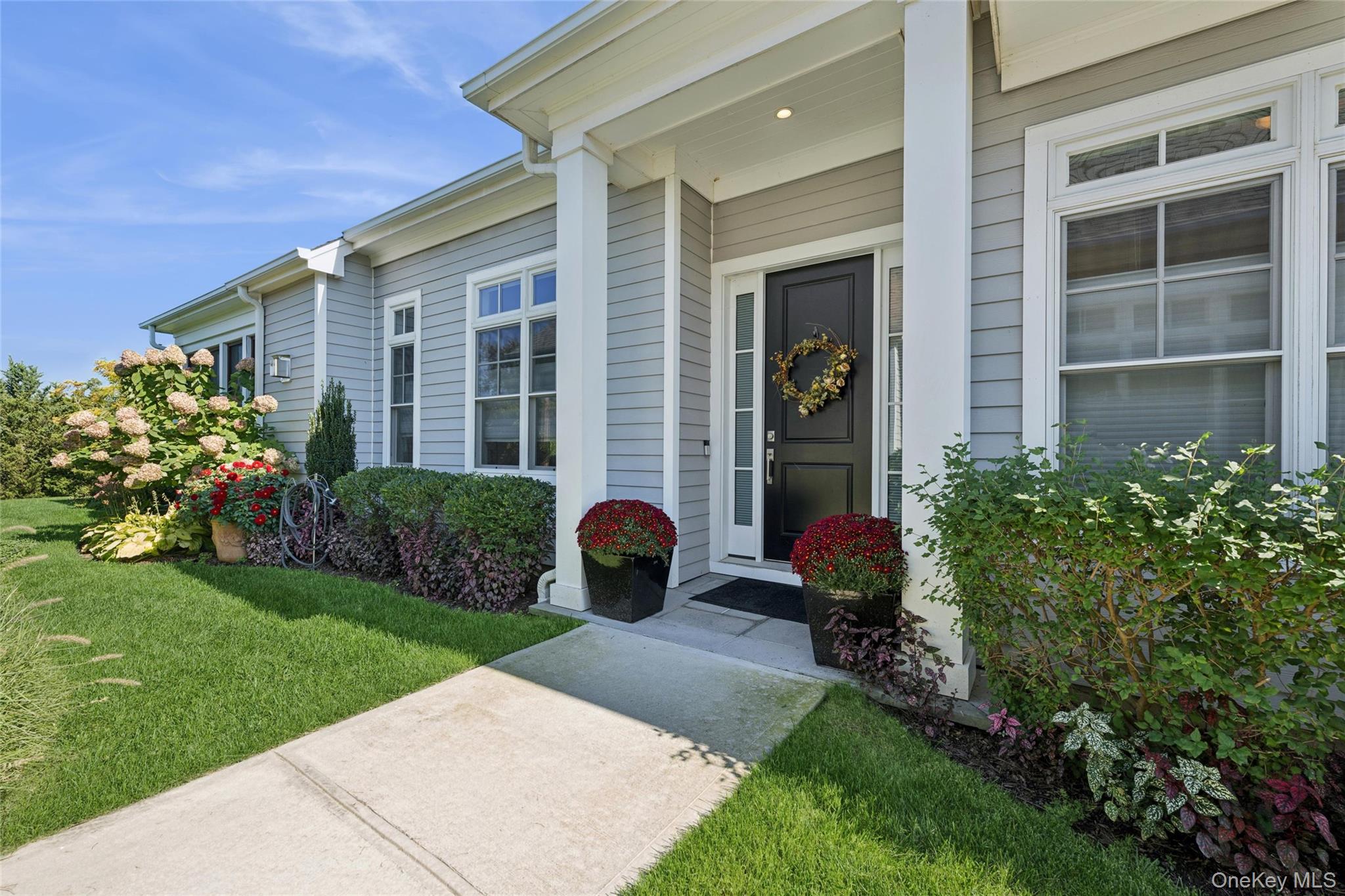 It is time to enjoy relaxed, modern living at Harvest Pointe, a 55+ community in Cutchogue!  This sought-after "Inkberry" model is overlooking the farm side of the community, offers 1,600 square feet of luxurious, single level living space.  This home has many upgrades and a spacious open floorplan with 12' ceilings and bonus powder room.  The living room offers a modern, linear gas fireplace with interchangeable stainless steel and matte black surround along with an exchangeable mantle to match the surround.  The kitchen features Bosch appliances, Shaker-style cabinets, Silestone countertops, an oversized sink with touch faucet, a separate filtered water faucet, and a pantry.   There are two bedrooms, each with an en suite bath and the primary features a large walk-in closet.  Immaculate 2-car garage has electric car hook up and epoxy floors, the full basement and an extended screened-in patio and a paved grilling area with a BBQ gas line.  Located three blocks from charming downtown Cutchogue and two miles from the beach, this home is perfect for those who want easy access to everything that the North Fork has to offer.  The Harvest Pointe community amenities include a pool, tennis, pickleball, bocce and large clubhouse with fitness center and wine lockers.