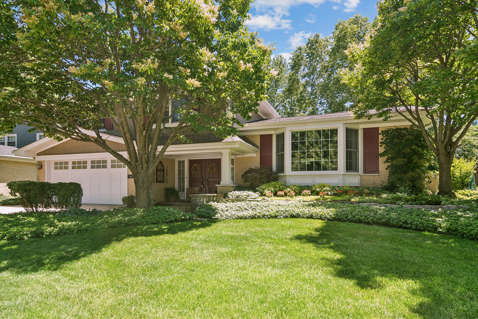 Truly one of a kind-this exceptional home set on one of the prettiest lots in Ivy Hill features expanded spaces, custom renovations, open flows, abundant natural light, extensive cabinetry, phenomenal outdoor space and an incredible amount of lifestyle amenities. Expanded and enhanced the interior feels modern and spacious. In the kitchen, an original builder upgrade added additional space and a large bay window that overlooks the gorgeous yard. The remodeled and combined dining room/kitchen opens to the living room creating wonderful flow for entertaining. A renovation more than doubled the cabinetry and added a workstation and bookcase. Outfitted with a Sub-Zero refrigerator/freezer, a Viking 6-burner gas range, 2 Thermador convection ovens, Draco warming drawer, commercial grade exhaust hood, and Bosch dishwasher, this space is a dream for both the home cook and professional chef. A 14' x 3' addition to the family room added large sliding glass doors and additional windows offering both beauty and function. The remodeled fireplace wall commands attention with stone-cladding, arched detail, lighting, and custom built-ins. A bench with storage and display niches was added and offers extra seating and a place to display your treasures. Reconfigured space adjacent to the family room created an entertainment hub with a 6' wet bar, custom cabinetry, glass display doors, and wine glass rack. Garage access was moved from this room into the foyer to expand the useable space and an oversized foyer closet was created to keep coats, shoes, and gear organized and out of sight. Upstairs you'll find 4 bedrooms including the primary featuring a walk-in closet customized with drawers + extra hanging space and an ensuite bath remodeled to include a walk-in shower, wide vanity, and hidden medicine cabinet (behind the artwork!). All bedrooms have ceiling fans and the 4th bedroom features a built-in desk/bookcase perfect for a home office set up or kids homework station. The lower level feels bright and welcoming and includes a large, finished area with 19' of built in cabinetry for organization and place to add your tv or gaming equipment. A large separate laundry area and abundant storage add to the ease of living here. The premium oversized lot and elevated outdoor space bring your lifestyle here to a whole other level.  An extended porch roof and remodeled entry, brick paver drive, and professional landscaping create impressive curb appeal that will make you happy to come home and be the envy of the block. Mature landscape and a brick paver patio make for a peaceful sanctuary at the end of the day and an impressive spot to entertain friends and family. Time to up your grilling game with the built-in natural-gas grill with side burner and storage drawers. Other notable upgrades include brick exterior + James Hardie fiber siding, energy-efficient Renewal by Andersen windows, Newer architectural shingle roof (2023), large-capacity, on-demand tankless gas water heater (2016), new furnace (2025), 200-amp electrical panel with extra capacity, whole-house natural-gas backup generator, abundant recessed lighting and automatic sprinklers. PLEASE EXCLUDE: 2 sconces in living room + eating area chandelier.
