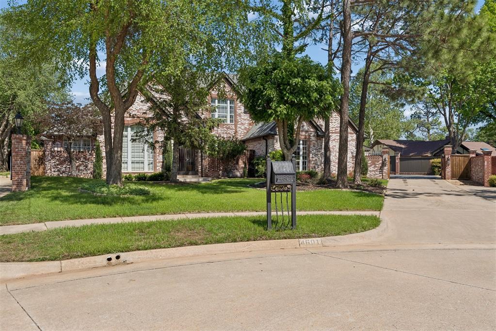 Welcome to exceptional living in one of West Norman's most coveted neighborhoods—Brookhaven. This stunning custom home combines timeless elegance, exceptional craftsmanship, and incredible spaces designed for both everyday living and unforgettable entertaining. From the moment you arrive, you'll be captivated by the striking curb appeal featuring the coveted brick exterior, mature landscaping, and a private iron-gated courtyard. Inside, a grand foyer with soaring ceilings and a sweeping curved iron staircase creates a breathtaking first impression. The thoughtfully designed floor plan offers the rare convenience of two bedrooms downstairs, including a luxurious primary suite with an expansive custom closet. A second main-level bedroom with a full bath is perfect for guests or a mother-in-law suite. The executive office features custom built-ins and ample space for one or two workstations. Travertine flooring and matching baseboards add timeless elegance throughout much of the main level. The gourmet kitchen boasts premium appliances, a six-burner gas cooktop, double ovens, abundant prep space, and opens seamlessly to the living areas. Walls of windows overlook the resort-style backyard with a sparkling pool featuring a recently installed liner. Entertaining is effortless with the incredible pub and billiards room, highlighted by a one-of-a-kind antique bar. A dedicated soundproof music, guitar, or theater room offers endless possibilities, while a pool bath with a built-in dog washing station adds everyday convenience. Upstairs you'll find three spacious bedrooms and two full baths. Additional features include a storm shelter in the garage, a third-car garage that can easily be converted back if desired, and premium turf covering much of the backyard for low-maintenance outdoor living. This extraordinary Brookhaven home offers luxury, versatility, and exceptional entertaining spaces rarely found in today's market.