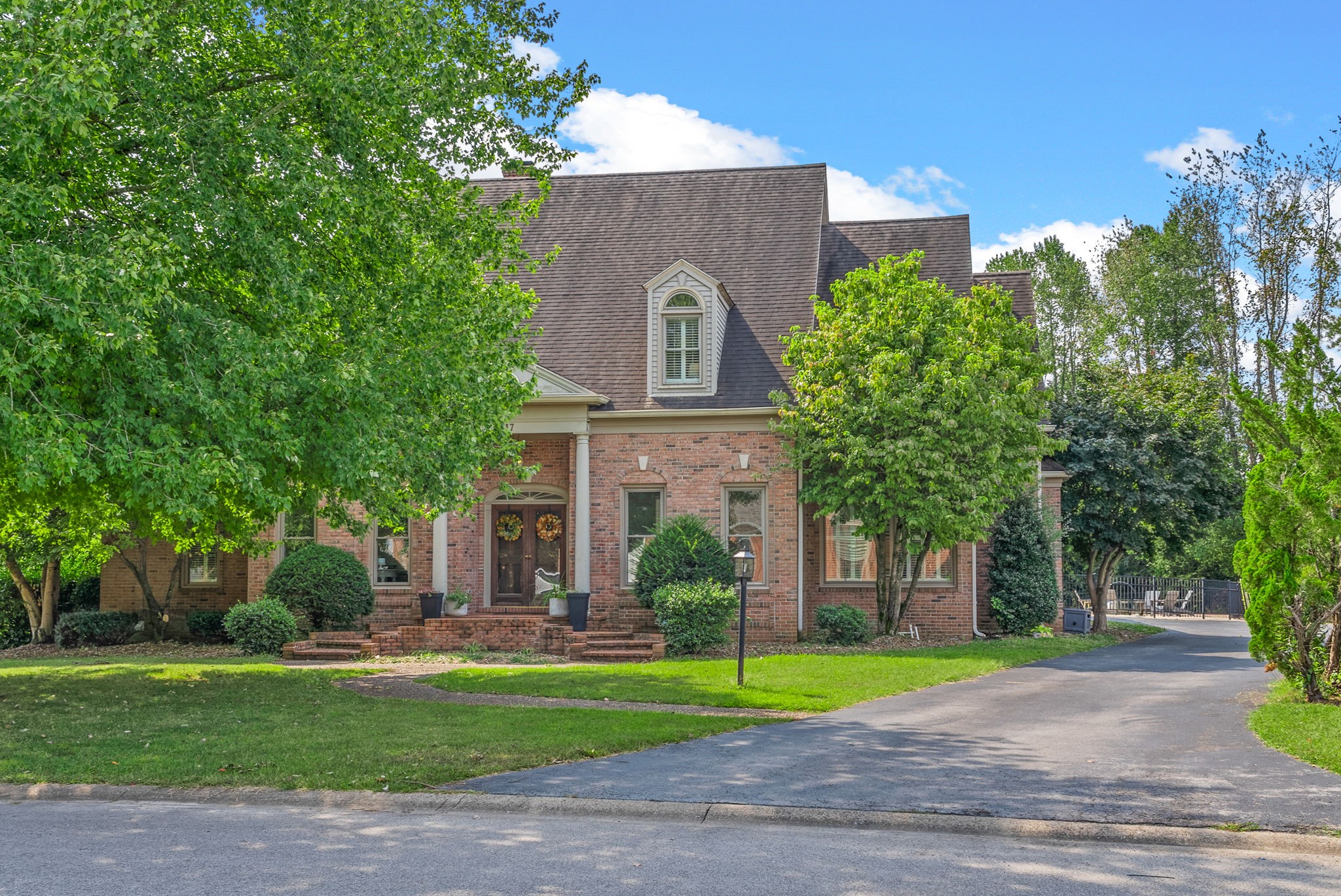 Stunning all-brick 5 bedroom, 3.5 bath home featuring a spacious bonus room with dual entries—one from inside the home and one from the garage. The open living room boasts soaring 23-ft ceilings, a cozy fireplace, and glass French sliding doors leading to the backyard. The large kitchen offers custom cabinetry, granite countertops, and plenty of workspace. Additional highlights include a workout room with washer & dryer hookups, a 9'5" x 16'8" screened porch, and abundant storage throughout. Outdoors, enjoy an in-ground saltwater pool with new pump, expansive patio space, and a pool house with half bath—perfect for entertaining. Home is equipped with 2 gas water heaters and 3 HVAC systems for comfort and efficiency. Large backyard completes this exceptional property!