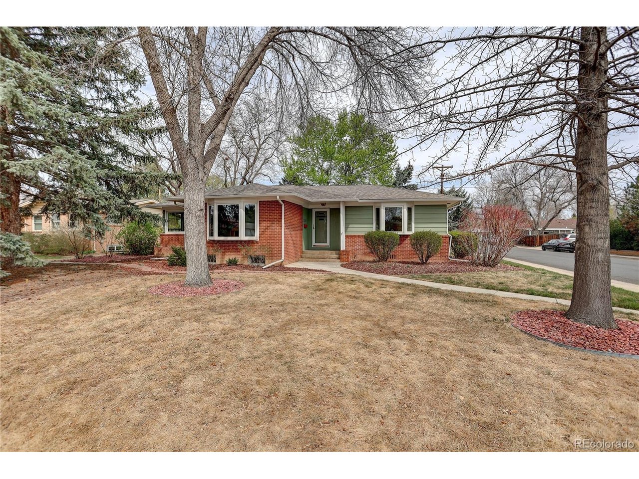 Solid Brick Ranch on a corner lot in a cul-de-sac steps from the Loveland Canal! This lovingly maintained home has an open main level with hardwood floors, large windows and a big bay window in the great room that keeps the home filled with light. Kitchen with abundant cabinetry and dining bar. Heated floor in the 5 piece bath with deep soaking tub. Basement offers a large living room/flex room with a bar, 4th bedroom and a bathroom. Enjoy a spacious fenced yard with mature landscaping, raised garden beds, flagstone patio, and powered awnings on both the patio and deck. Oversized 2-car garage with ample storage. No HOA bring your toys! Boiler and a/c are only 2 years old! All of this and just about 1 a mile to downtown.
