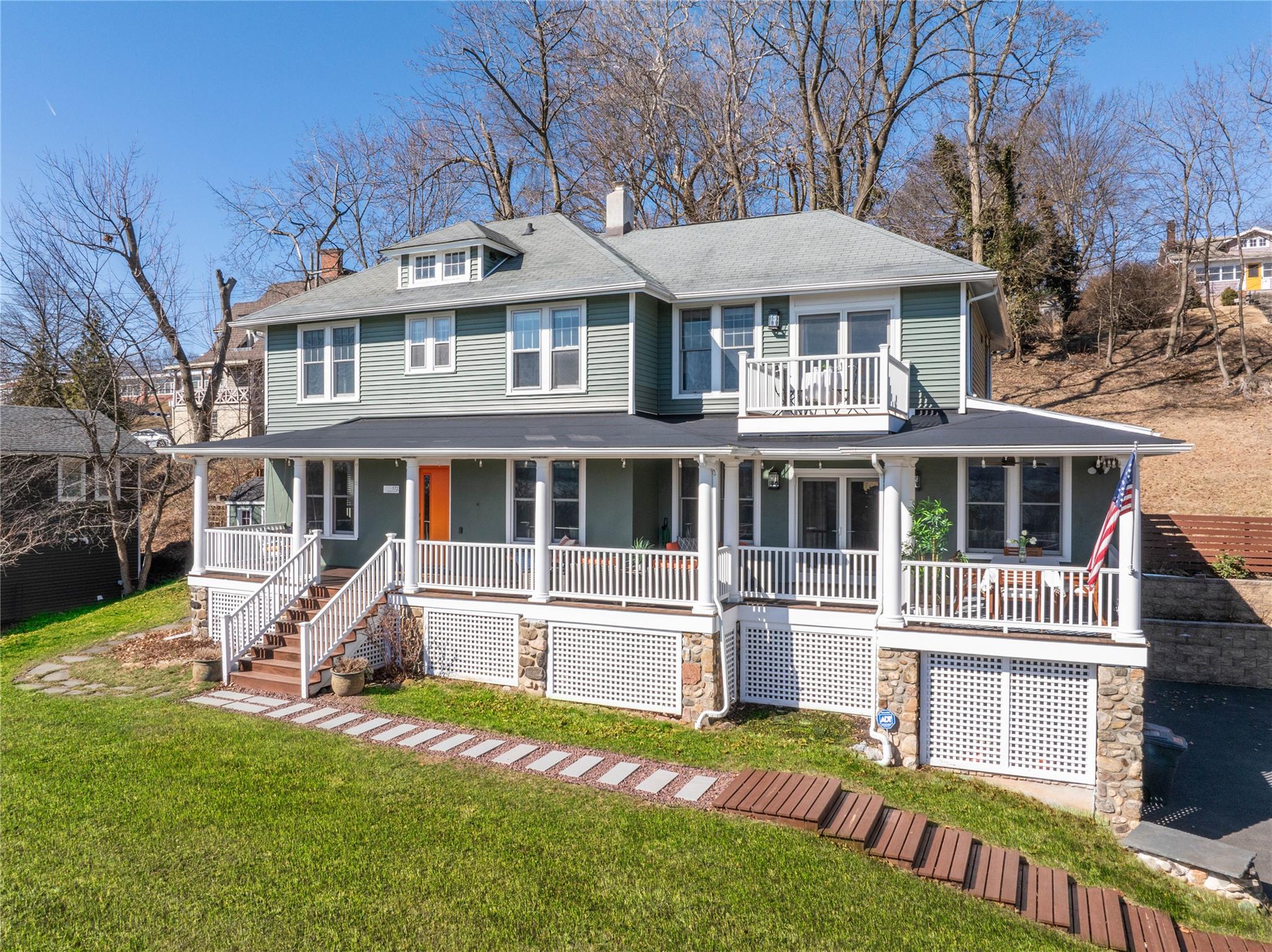 Only a few blocks from the charming Village of Nyack, this beautifully updated 4-bedroom, 3 bath Colonial seamlessly blends timeless elegance with modern convenience. From the classic lemonade porch to the thoughtfully designed interior, every detail has been meticulously maintained to create a warm and inviting retreat. Step inside to discover spacious, sunlit rooms, including a stylish kitchen with custom banquet seating and a generous butler’s pantry for ample storage. The open living room, anchored by a cozy gas fireplace, flows effortlessly onto the front porch through french doors—perfect for easy indoor-outdoor living. A private entrance leads to a flexible space that can serve as an office/gym, or guest room, while the fully finished basement expands your living and storage options. Designed for both relaxation and hosting, the backyard features a generous patio with a convenient gas hookup for your BBQ, a shed for extra storage, and french drains for easy maintenance. Revel in the breathtaking Hudson River and Mario Cuomo Bridge views from your private primary suite balcony, or entertain in style on the spacious front porch—ideal for dining, unwinding, and enjoying the Fourth of July fireworks. Additional features include a custom walk-in closet in the primary suite, attic storage, a freshly painted exterior, updated bathrooms, central air, an alarm system, and a one-car garage. This is a rare opportunity to own a home that combines historic charm and modern upgrades—all just minutes from Nyack’s vibrant shops and restaurants!