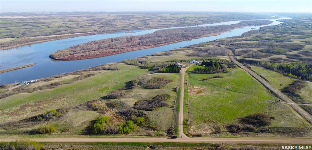 Exclusive North Saskatchewan Riverfront Estate – 59.7 AcresExperience the ultimate prairie retreat with this rare 59.7-acre riverfront property in the RM of Corman Park No. 344.Located northwest of Langham, this expansive estate offers breathtaking views of the North Saskatchewan River and isperfectly equipped for both luxury living and agricultural pursuits.The ResidenceThis meticulously maintained 1,560 sq. ft. bungalow, built in 1994, features a fully developed walk-out basement,doubling your functional living space.Main Floor: Features a spacious kitchen and dining area with hardwood flooring, two bedrooms with plush carpeting, adedicated laundry room, and a stunning sunroom with tiered views.Basement: Includes two additional large bedrooms, a sprawling family room with tile flooring, a wood stove for cozy winters,and significant storage space.Garage: A fully insulated 28' x 23' double attached garage ensures your vehicles are protected year-round.Exceptional Outbuildings & Infrastructure The property is a turn-key setup for livestock or hobby farming, featuringhigh-quality structures.Barn/Shop (40' x 34'): A unique dual-level structure with a shop on top and a barn below. The barn features cement walls,stalls, and pens, while the shop includes wood walls/floors, stucco exterior, and asphalt shingles.Specialized Equipment: Includes a walk-in cooler (8'3" x 12'6"), an oat bin, working water bowls, a cattle squeeze, andan alley system.Additional Amenities: A greenhouse for gardening enthusiasts and a dedicated kids' play structure.Land & Location The terrain is gently rolling to hilly, consisting of 57 acres of pastureland and a 3-acre yard site.Water Security: Features a crib in-river pump that supplies water directly to the barn and house.Enjoy complete seclusion with a property that is fully fenced (cable and barb).