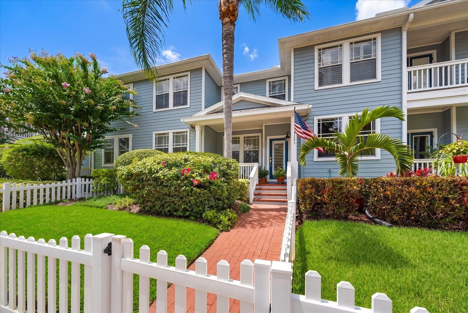 Welcome to West Bay Village, an upscale, pet-friendly executive townhome community nestled in the heart of Largo's Historic District. With charming white picket fences, vintage streetlights, brick-paved streets, and beautifully manicured landscaping, this picturesque neighborhood offers timeless curb appeal and an exceptional lifestyle.This beautifully maintained 3-bedroom, 2.5-bath townhome radiates warmth and character from the moment you arrive. Follow the brick walkway through the private fenced yard to the inviting covered front porch—an ideal place to enjoy your morning coffee or relax in the evening.Step inside to a spacious, light-filled floor plan featuring 9-foot ceilings, crown molding, plantation shutters, rich wood flooring in the living and formal dining rooms, and abundant natural light. Designed for both comfortable everyday living and effortless entertaining, this home is truly move-in ready.The well-appointed kitchen is the heart of the home, offering 42-inch cabinetry, a breakfast bar, generous counter space, newer SS LG appliances, and a large walk-in pantry. Adjacent to the kitchen, the elegant formal dining room showcases a tray ceiling and chair rail, creating the perfect setting for family gatherings and holiday dinners. A conveniently located half bath completes the first floor.Upstairs, the thoughtfully designed split-bedroom floor plan provides privacy for everyone. The expansive primary suite features a huge walk-in closet and a luxurious ensuite bath with dual vanities, a relaxing garden tub, separate shower, and private water closet. Two additional spacious bedrooms, each with large walk-in closets, share a full bath. An oversized laundry room with washer, dryer, utility sink, and shelving add everyday convenience.Storage is abundant throughout the home, including the oversized two-car garage with an enormous storage closet and plenty of room for a workshop, bicycles, golf cart, or recreational gear. Outside, enjoy your private fenced yard and welcoming front porch.West Bay Village offers one of Largo's most walkable locations. Just two blocks away, Ulmer Park hosts farmers markets, concerts, and community events throughout the year. You'll also enjoy easy access to Publix, shopping, restaurants, medical facilities, Largo Central Park, the Performing Arts Center, the Pinellas Trail, dog parks, post office, playgrounds, volleyball courts, movie theaters, and top-rated schools.Exciting new development is underway just blocks away with the upcoming Largo Entertainment District, including Horizon West Bay, Largo's new City Hall, Liberty Yards, boutique shopping, restaurants, and cafés.Best of all, you're only five minutes from the Belleair Bridge and the sparkling Gulf beaches, where you'll enjoy soft sand, turquoise waters, waterfront dining, boutique shopping, and breathtaking sunsets.No flood insurance required! Situated approximately 70 feet above sea level and not located in a flood zone, this exceptional home combines luxury, convenience, and peace of mind in one of Largo's most desirable communities.