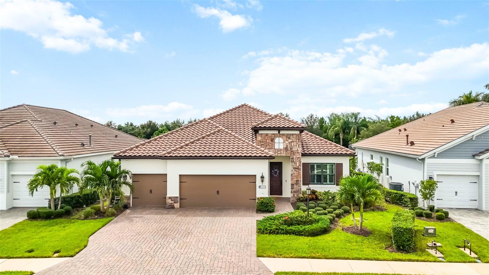 Welcome to Indigo, a gated, maintenance free community surrounded by nature, offering a peaceful setting in the heart of Lakewood Ranch. This Neal-built Daybreak floor plan offers both space and versatility, featuring 3 bedrooms, 2.5 bathrooms, an office/den, and both a formal living room and a spacious great room. Thoughtfully designed, this 3-way split floor plan provides just the right amount of separation and flow with plantation shutters and wood-look tile floors throughout. The primary suite is tucked away on one side for privacy, complete with a coffered ceiling, custom accent wall, two walk in closets, and a serene en suite bath. On the opposite side of the home are two additional bedrooms, while an office sits at the back of the home, ideal for working remotely or hosting guests, with convenient access to the pool bath. The formal sitting room at the front of the home adds extra flexibility and can easily be transformed into a second office, den, or playroom. At the heart of the home, the open concept great room and gourmet kitchen create a warm and inviting atmosphere, with a large center island, gas range, walk-in pantry, and seamless flow into the dining area. A coffered ceiling with wood inlays, built-in speakers and a new built-in electric fireplace and adorns the great room adding a touch of warmth and sophistication. Enjoy Florida living at its finest in the beautiful and private outdoor space, featuring peaceful water views, a sparkling saltwater pool with sun shelf, a built-in summer kitchen, and plenty of deck space to relax or entertain. The home features hurricane impact windows for year-round peace of mind and is located in the desirable “X” flood zone.
Indigo residents enjoy access to resort style amenities including a heated community pool, pickleball courts, clubhouse, fitness center, playground and lifestyle director. All just minutes from top-rated Lakewood Ranch schools and the vibrant shopping, dining, and events that make the area so desirable.
