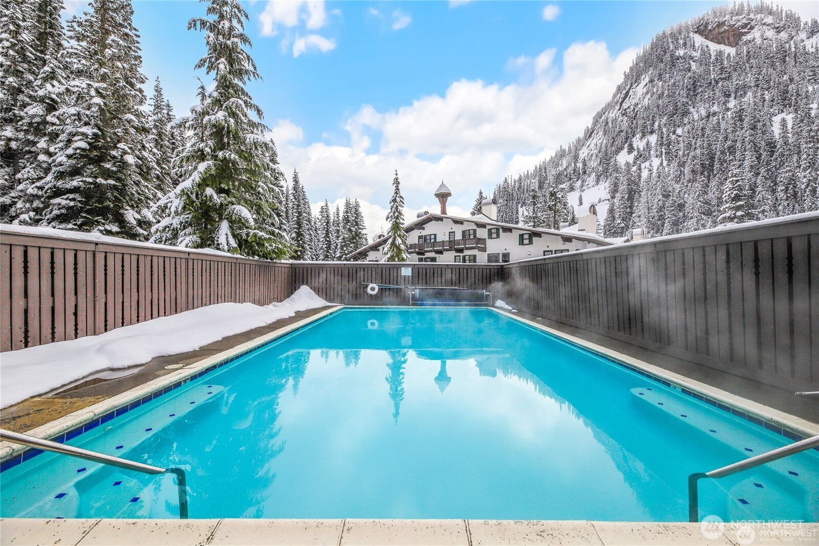 Experience the ultimate alpine lifestyle in this meticulously designed 508 sq ft Alpental condo! Perfectly optimized for mountain living, this unit features two bedrooms/sleeping lofts , offering impressive space and versatility.Step out onto your private deck to take in breathtaking, unobstructed views of the headwaters of the Snoqualmie River, Denny Mountain, Chair Peak, and the iconic Alpental Ski Area. After a day on the slopes or nearby hiking trails—both just steps from your front door—return home to the comforting crackle of a brand-new wood stove, designed to keep you cozy and your ski gear bone dry all winter long. Premium Amenities Include: Year-Round Outdoor Pool: Heated to a resort-style 100°F in the winter and soaked in maximum sunshine all summer. Relaxation: Access to the shared his-and-hers community sauna.  Peace & Quiet: Fall asleep to the soothing sounds of the rushing river.  Best of all? This particular unit boasts notably low HOA dues, making it an incredible, low-maintenance investment or weekend getaway. Don’t miss your chance to own a piece of Alpental paradise!