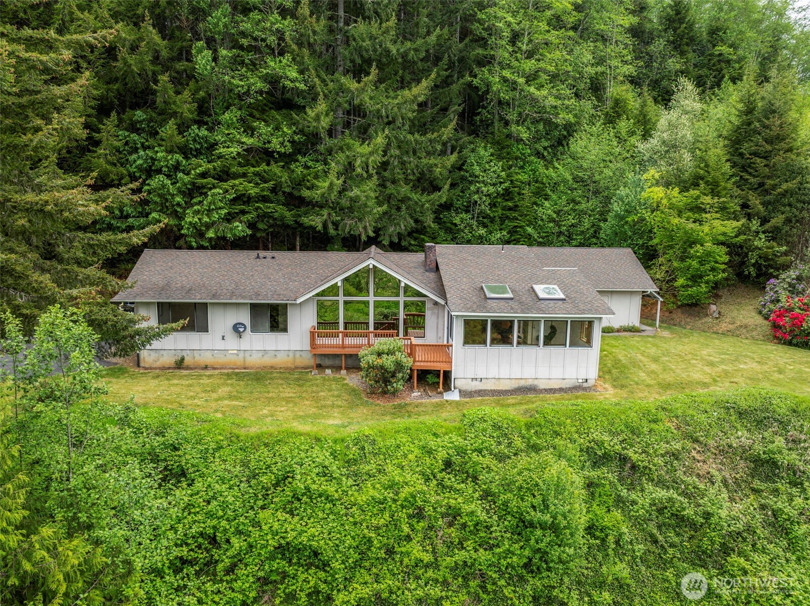 Enjoy the territorial, partial river views & sounds of nature in Skamokawa on your own 20+ acre TIMBER FARM! Stick-built home has 2 BR, 2 BA plus Sunroom/Atrium & detached guest quarters w/partial bath. Vaulted great room, lovely views, wood burning fireplace, large efficient kitchen w/newer stainless appliances, dining space & ISLAND seating where the views continue. Asphalt parking apron, garage & two carports afford space for vehicles, guests, toys & equipment. Private & peaceful one-owner home perched on a plateau at the end of paved driveway w/great bones awaits personal touches from new owner. Well & septic, furnace & heat pump, workshop, covered wood storage, ramped entrance to front deck, back deck off atrium, TRAILS & TIMBER!