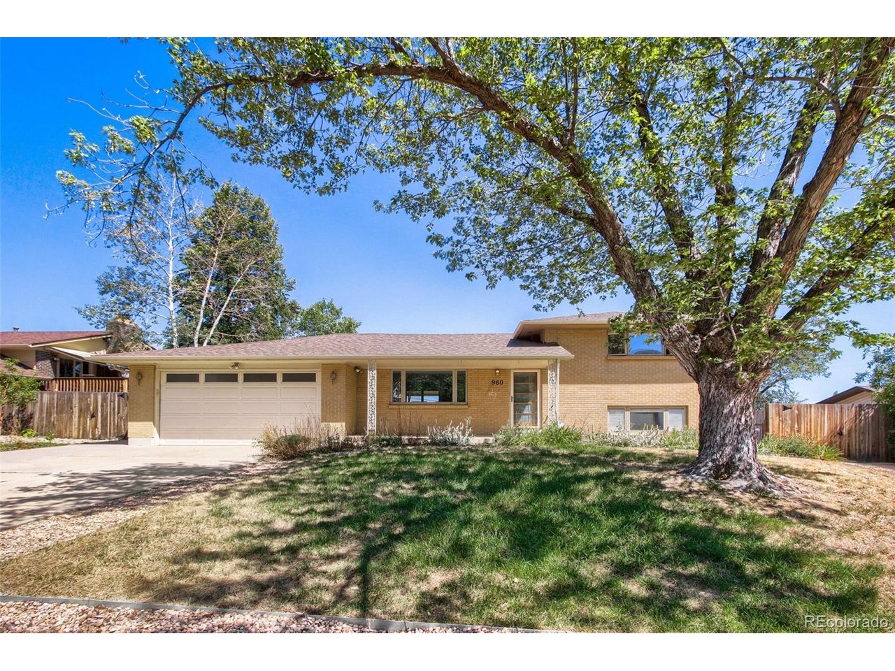 Stunning Remodel in Highly Desirable Green Mountain!Tucked away on a quiet street with sweeping city light views, this updated home sits on a spacious lot offering both privacy and space to entertain. The kitchen has been updated with quartz countertops, new stainless steel appliances, new cabinetry with soft close, beautiful tile backsplash, and an open layout with bar seating. The main level features stylish new LED lighting. New LVP flooring flows through the main level, while the upstairs hardwoods have been beautifully refinished.The remodeled bathroom featuree quartz counters, new tile flooring, and a fully updated shower. Updated windows throughout add efficiency and peace of mind.Outside, enjoy a covered patio with paver stones; perfect for relaxing or entertaining while taking in the privacy and views. A large 2-car garage plus a separate driveway with trailer/RV parking offers rare extra space and flexibility.Just a short walk to Green Mountain trails, with easy highway access to the mountains or anywhere in the Denver Metro area, this home offers the perfect blend of nature, convenience, and modern comfort.*Some photos feature virtual staging