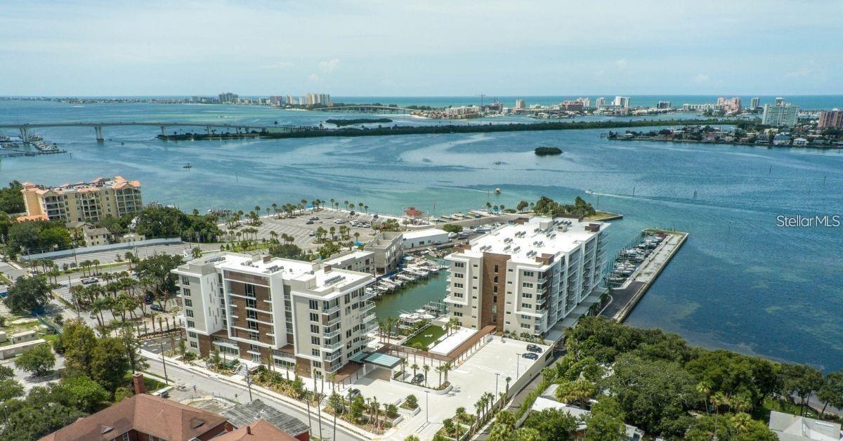 BRAND NEW PRICE! Come experience the pinnacle of luxury living at 920 North Osceola, Unit 801—a rare, end unit penthouse in one of Clearwater’s most exclusive waterfront developments. This corner unit dazzles with soaring 12 to 13-foot ceilings, filling the space with natural light and offering sweeping city and water views and extra privacy. The thoughtfully designed 1,800-square-foot floor plan includes two bedrooms, two baths, a spacious 12 × 11 den that provides elegant flexibility as a refined home office or third bedroom, a modern kitchen with quartz countertops, a large center island with seating and a spacious walk-in closet in the primary suite. Modern wood accents, electric shades and two private balconies with access from both bedrooms, invite the serenity of the waterway inside  and provide front-row views of both sunrises and sunsets from this South facing unit. Resort-style amenities elevate everyday living: a 25-meter saltwater lap pool with Baja shelves, sauna, steam room, state-of-the-art fitness center, putting green, elegant clubroom, full concierge service, and more. Nestled directly on the intracoastal, this newer development offers a marina nearby with 69 boat slips and 47 lifts which you can discuss with the marina directly (not connected to this property). Residents indulge in resort-style amenities—a 25-meter lap pool, sauna, steam room, fitness center, putting green, club room with pantry, and 24/7 concierge service. With two garage parking spots (19 and 110), this home is built to the highest modern standards, delivering an unrivaled lifestyle in the heart of Clearwater. Worry-free living at its best! Schedule a Showing Today!