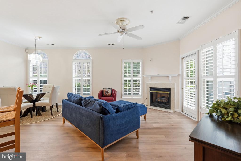 This light-filled condo in sought-after Hunters Branch features an open floor plan, creating an inviting and functional living space. Large windows with custom treatments, including plantation shutters, flood the home with natural light, while new luxury laminate wood floors add both elegance and durability. The updated kitchen blends style and practicality with stainless steel appliances, new countertops, a classic tile backsplash, and under-cabinet lighting.Both bedrooms feature en-suite bathrooms and offer spacious walk-in closets, complemented by additional storage just off the entry. A full-size, side-by-side washer and dryer add everyday convenience, while the cozy gas fireplace enhances the living area for colder nights. The home also includes a private patio and a brand-new butterfly entry system, completing this well-appointed and comfortable residence.Residents enjoy a host of community amenities, including a swimming pool, clubhouse, playgrounds, picnic areas, and scenic walking trails. The property includes one assigned garage parking space, along with ample guest parking for added convenience.Ideally located near the Vienna/Fairfax-GMU Metro Station - a five minute walk - and major commuter routes such as I-66, Route 29, Route 50, and I-495, this home offers exceptional accessibility. Enjoy nearby destinations like the Mosaic District, Pan Am Shopping Center, Nottoway Park, Fair City Mall, Oak Marr Golf Center, Vienna, and Whole Foods Market.