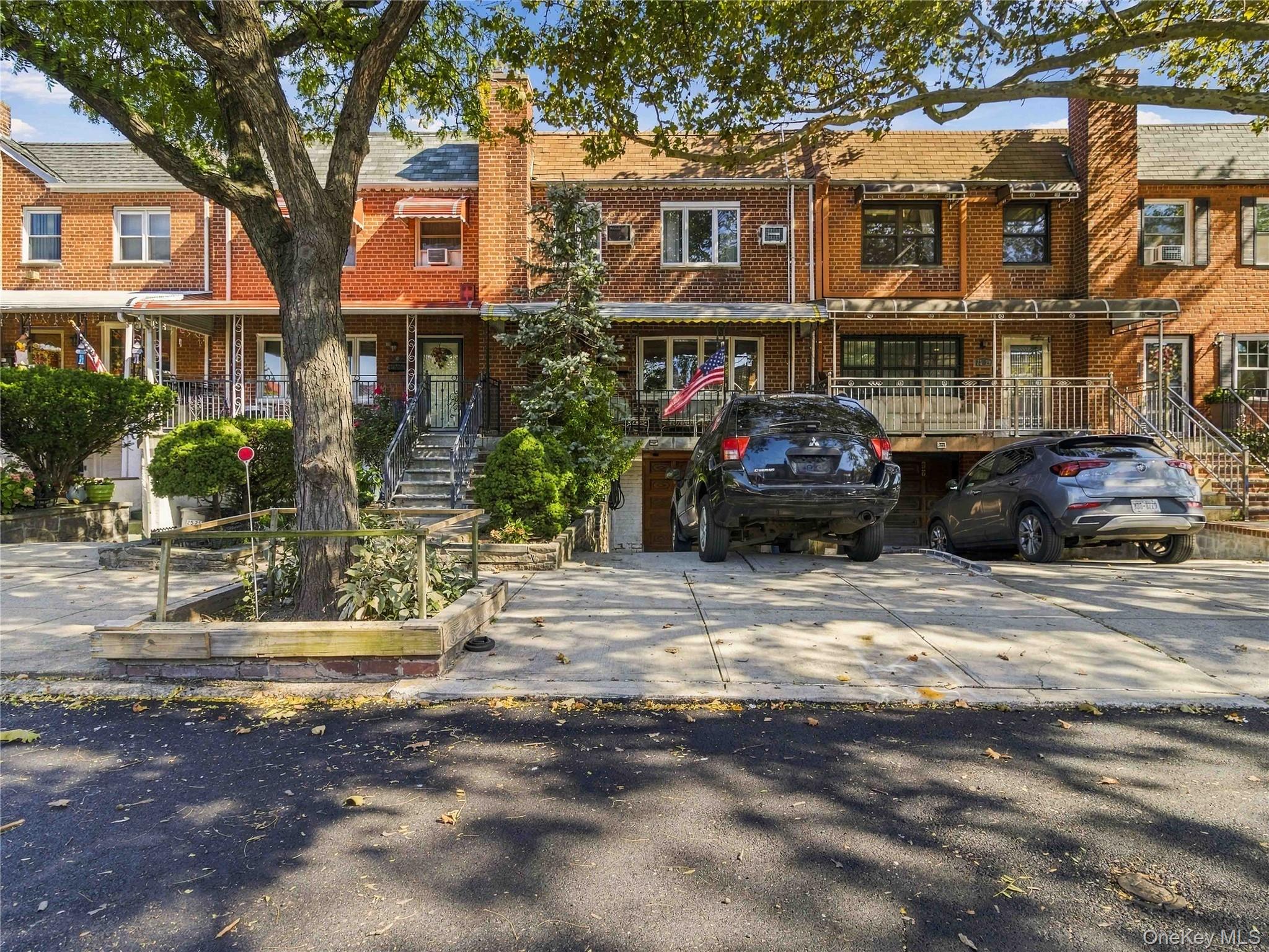 Welcome to this spacious, beautifully maintained brick townhouse in Jackson Heights. The main level features an entry foyer, bright living room with hardwood floors, formal dining room, half bathroom, and an eat-in kitchen with solid wood cabinetry, granite countertops, tile backsplash, gas cooking, dishwasher, bay window, and a pass-through breakfast bar. Sliding glass doors off the dining area lead to an elevated rear deck and a fully fenced grassy yard. The upper level offers three bedrooms (including an office/bedroom option) and a full bathroom. The full finished basement includes a separate entrance, dedicated laundry room with washer/dryer, and extra flexible living space. Complete with an attached 1-car garage and private driveway. Conveniently located near local dining, shopping, parks, schools, and transit including the Q47 bus.