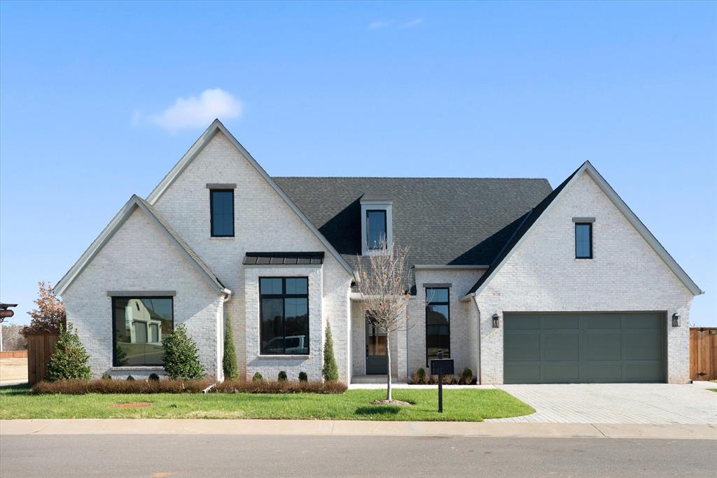 A fresh take on luxury living in East Edmond, crafted by Ripple Creek Homes. This home in Stone Hill Cottages at Iron Horse Ranch blends modern design, thoughtful details, and low-maintenance living without sacrificing privacy or outdoor space.

Warm white oak wood floors, designer lighting, and a zellige-tile fireplace set the tone the moment you enter. Large windows bring in excellent natural light, and a dedicated study off the entry provides the perfect workspace or flex room.

The kitchen features a commercial-grade Thor gas range, oversized island, walk-in pantry, and custom cabinetry. The spa-like primary suite includes a wet-room style bath with a frameless glass, curbless shower room and a soaking tub for a true retreat experience. You’ll love the direct access to the utility room from the primary closet, adding ease to daily living.

Secondary bedrooms are spacious and versatile for guests, hobbies, or quiet relaxation.

The private fenced backyard is designed for year-round enjoyment with a covered outdoor living space, fireplace, and a turf putting green—a perfect spot to unwind at the end of the day.
Enjoy new construction, timeless finishes, and a community with a pool, clubhouse, yard maintenance, and walkability—minutes from Edmond dining, shopping, and conveniences.

Experience lock-and-leave luxury with signature Ripple Creek quality.
