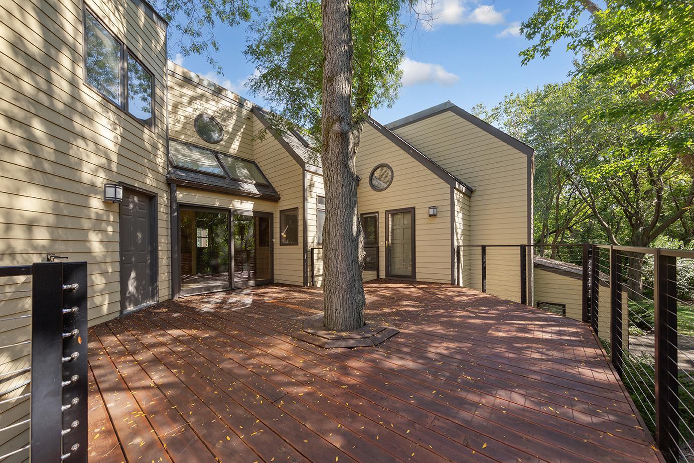 Welcome to this one-of-a-kind luxury home nestled on a park-like .71-acre lot in the highly sought-after Bush Lake neighborhood of Bloomington. With 5 bedrooms, 5 bathrooms, and over 5,500 square feet of beautifully designed living space, this home blends mid-century modern charm with comfort, privacy, and functionality. Step inside to discover bright, open spaces filled with natural light, a sun room and a three-season porch perfect for enjoying Minnesota’s changing seasons, and a main-level office ideal for working from home. This thoughtfully designed layout includes two expansive primary bedroom suites, offering flexibility for multi-generational living or luxurious guest accommodations. The chef's kitchen opens to spacious dining and living areas, while the home’s architectural details and timeless design create a warm, inviting atmosphere throughout. The homeowners are currently replacing the basement patio doors, with installation scheduled for early November—an added upgrade to enhance the lower level’s comfort and functionality. The roof and siding were replaced in 2012, providing peace of mind and long-term durability. Outside, you'll fall in love with the serene, landscaped setting — mature trees, lush greenery, and quiet privacy make it feel like your own private park. And don’t miss the huge bonus storage space. With a 3-car garage, ample storage, and a location just minutes from Bush Lake, parks, and trails, this property truly has it all.