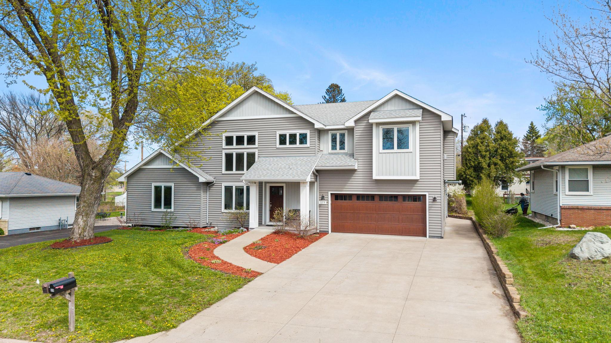 Located just down the street from parks and Edgerton Elementary, this spacious 5-bedroom, 4-bathroom Maplewood home blends everyday comfort with a thoughtfully designed, flexible layout.The main level welcomes you with 18-ft ceilings and walls of windows that fill the home with natural light. The inviting living room, complete with built-ins and a cozy gas fireplace, flows easily into the informal dining area.The kitchen is both stylish and functional, featuring stainless steel appliances, tile backsplash, a center island with seating, walk-in pantry, under-cabinet lighting, and a built-in desk/drop zone. Walkout access leads to the backyard with an accessibility ramp for added ease. Three main-level bedrooms and a nearby full bath with roll-in shower offer great versatility.Upstairs, a loft and bonus room with a sink and cabinetry create the perfect space for hobbies, work, or relaxation.The upper-level private primary suite lives like its own independent retreat, complete with a full kitchen, living and dining area with a fireplace, vaulted ceilings, dual closets, additional walk-in closet with laundry hookups, and a spacious ensuite bath.The lower level expands the living space with a large family room, fifth bedroom, ¾ bath, laundry with utility sink, and excellent storage.Enjoy the beautifully designed outdoor space with a patio, gazebo, water feature, heated 2-car garage, and attached workshop.