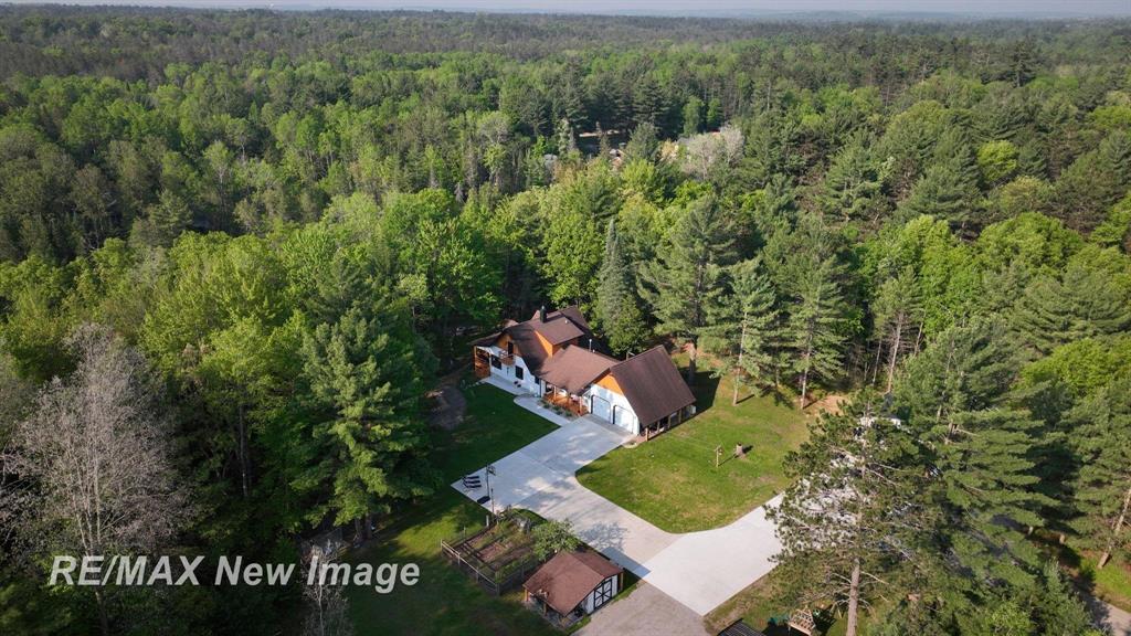 Heaven on High Road!  Welcome to your Northern Michigan waterfront dream home, offering the perfect balance of privacy, comfort, and outdoor adventure. This spacious 2,594 square foot home features four bedrooms and two full bathrooms, with two bedrooms and one bathroom on each level, ideal for guests or multi-generational living. Set on six private, wooded acres at the very end of a quiet dead-end road, the property boasts an incredible 500 feet of frontage on the beautiful AuSable River-perfect for kayaking right from your backyard.  The home has been thoughtfully updated inside and out. Recent upgrades include new granite countertops in the kitchen, updated lighting and fixtures throughout, a new pellet stove, and new flooring on the main level. Both bathrooms have been modernized, and the entire home has been freshly painted inside and out. Main floor laundry adds convenience, while a finished partial basement provides bonus living or storage space. A whole-house Generac generator ensures year-round peace of mind.  Outdoors, you'll find a spacious deck overlooking the river, a cozy fire pit by the water, and stunning scenery full of deer and wildlife. The property includes a brand-new 32x40 pole barn with 10-foot doors, gas, and water-perfect for storing toys or setting up a workshop. There's also a 2.5-car heated garage, three outbuildings, a carport, all-new concrete work, and a newer septic tank and drain field. Located just five minutes from Roscommon and fifteen minutes from Higgins Lake, this serene retreat is close to ATV trails and endless recreational opportunities.  This one-of-a-kind property truly offers something for everyone, whether you're seeking a year-round residence, a vacation getaway, or a nature-filled escape. Don't miss your chance to own this incredible slice of Northern Michigan paradise.