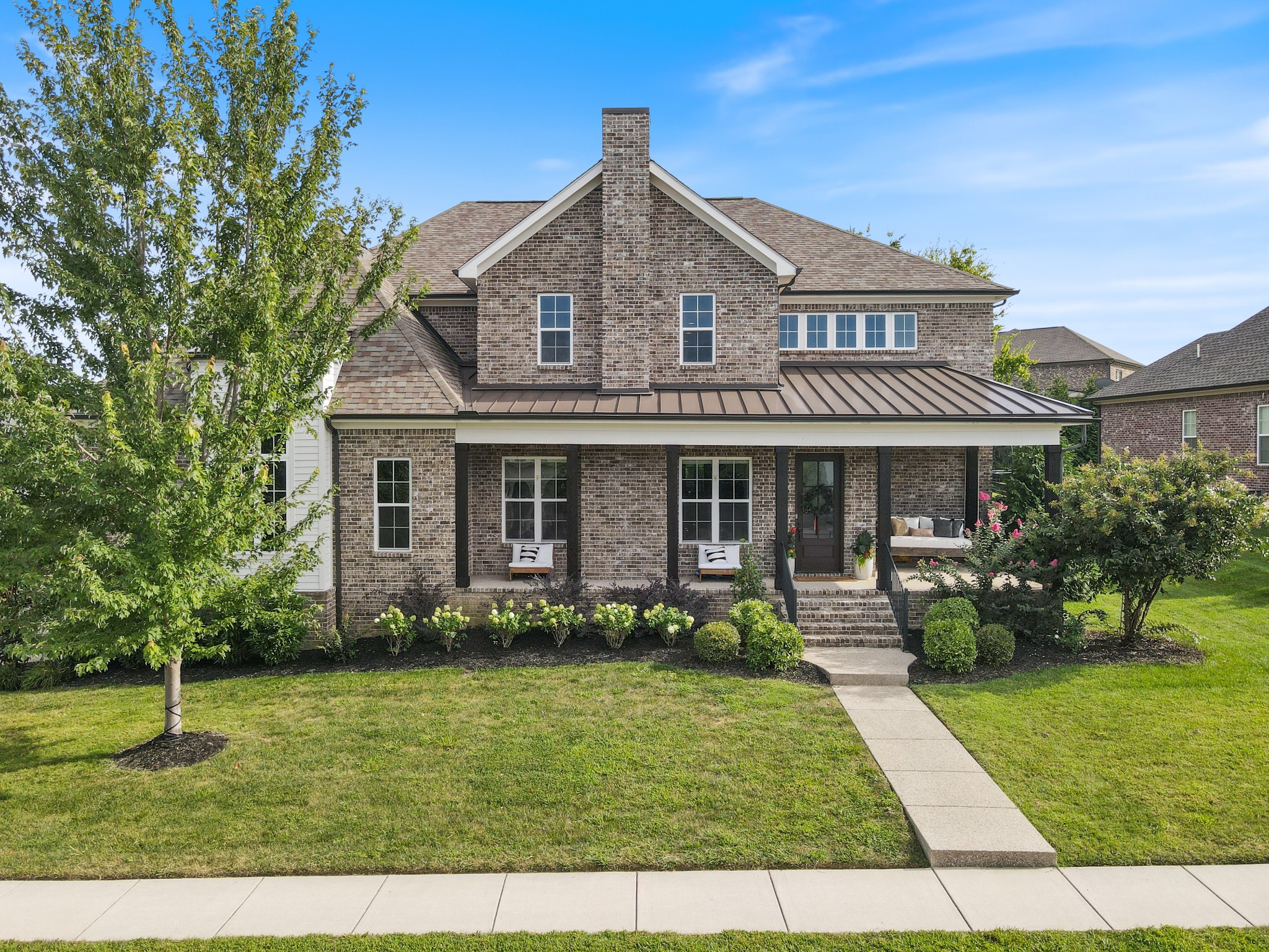 Welcome to Luxury Living in Scales Farmstead. Built in 2020 by KDEN Homes, this custom residence was designed to rise above the ordinary. Tucked away on a quiet cul-de-sac, the wraparound front porch and curated landscaping set the stage for elevated living that continues throughout.

Inside, the main level offers a serene primary suite with vaulted ceilings and spa-like bath, alongside a versatile second bedroom ideal for guests, a nursery, or a private home office. The gourmet kitchen, complete with quartz countertops and premium Frigidaire appliances, flows seamlessly into open living spaces designed for entertaining or enjoying quiet mornings at home.

Upstairs, three additional bedrooms and an oversized bonus room create space to gather, grow, and retreat. Every detail has been thoughtfully curated, custom wall treatments, designer wallpaper, and climate-controlled storage blend beauty with everyday function.

Step outside to discover outdoor living at its finest: a covered porch for morning coffee, a backyard shaded by mature trees, and a Marmiro natural stone bi-level patio with recessed lighting. The fire bowl centerpiece ensures evenings outdoors feel like a five-star experience.

Life in Scales Farmstead offers more than just a beautiful home, it’s a community built for connection. Stroll the scenic walking trails, spend afternoons at the resort-style pool and clubhouse, or let the kids enjoy the playground. Food Truck Wednesdays, outdoor movies, and neighborhood gatherings bring neighbors together and create a true sense of belonging.

Ideally located less than 5 minutes from Brentwood and Franklin, and minutes to Cool Springs and I-65. The property is also zoned for award-winning Williamson County schools including Jordan Elementary, a Blue Ribbon school consistently ranked among the best in the county.

More than a home, this is a retreat where elevated design, comfort, and community come together.