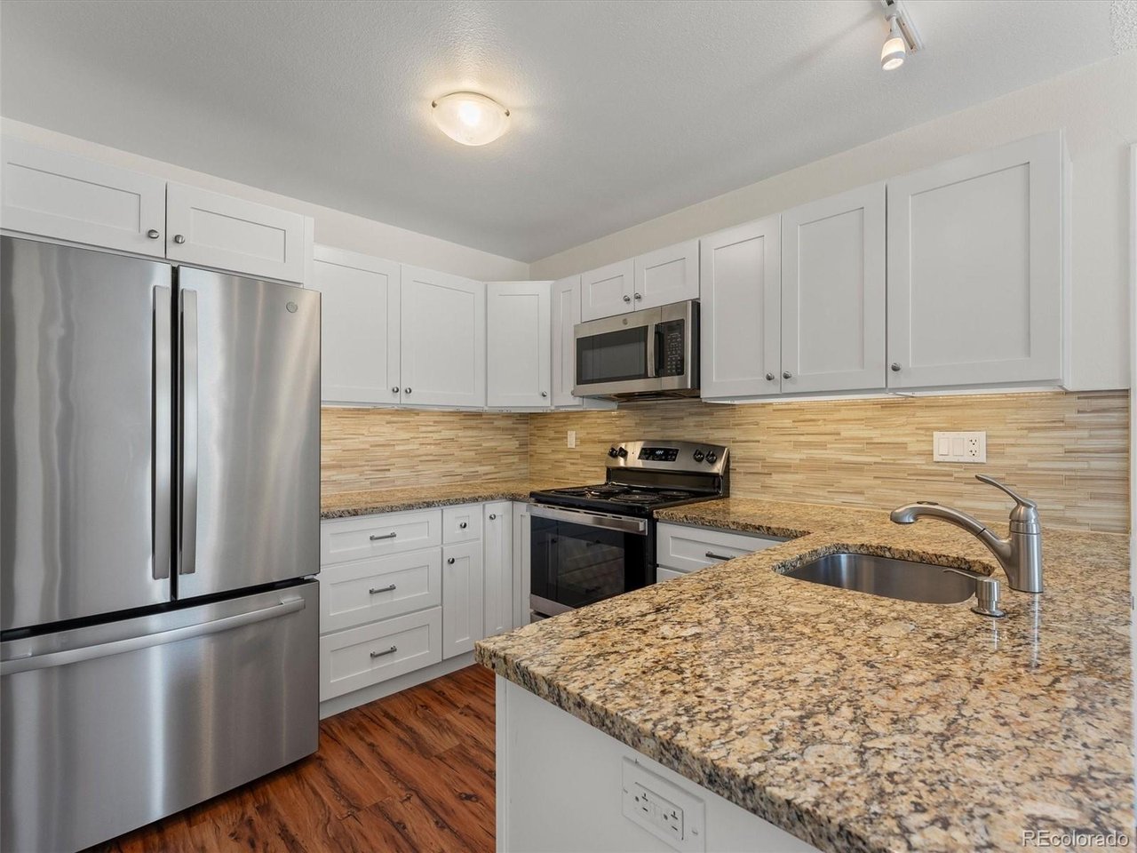 Welcome home to this move-in ready tri-level gem in Parker, offering the perfect blend of modern updates, convenience, and outdoor living. Situated in a prime location just minutes from major highways and vibrant retail centers, this property combines everyday accessibility with a peaceful neighborhood feel.Step inside this immaculate home, offered at an incredible price and maintained in amazing condition. The bright and inviting multi-level layout is elevated by stunning engineered flooring that delivers the timeless look and warmth of authentic hardwood throughout the main living areas. The updated kitchen features sleek granite countertops and ample workspace, making meal prep and entertaining a delight. Fresh paint gives the entire home a crisp, clean, and turn-key feel from the moment you cross the threshold.The impressive updates continue outside into your private backyard retreat. The yard has been beautifully and professionally landscaped with lush new sod, while an elegant custom flagstone patio and walkway in the back creates the ideal space for weekend barbecues and outdoor relaxation. Storage is never an issue here, as the property includes a convenient one-car garage along with a large detached storage shed, perfect for housing tools, lawn equipment, or seasonal gear. With a brand-new roof providing ultimate peace of mind and protection for years to come, this home is truly a rare find that is completely ready for its next owner to move right in.