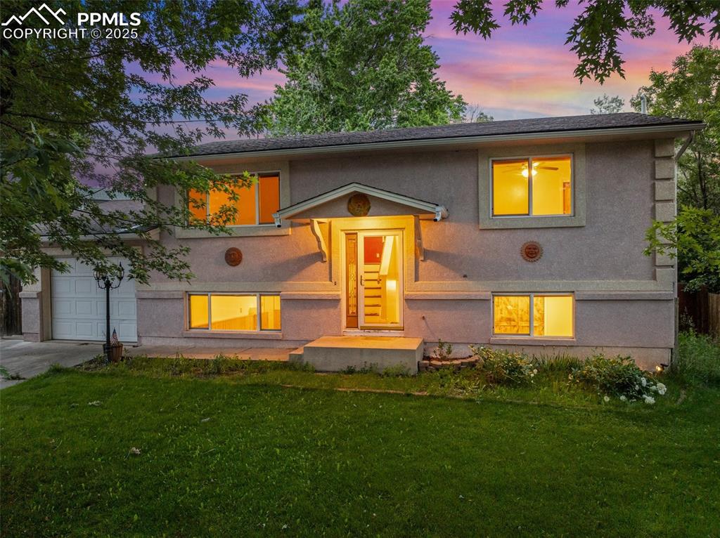 Charming Bi-Level Home with Koi Pond Oasis in Vista Grande West! Welcome to 5027 Galena Drive, an adorable 4-bedroom, 2-bathroom home tucked away in a peaceful, park-like setting in Colorado Springs. Located in the desirable Vista Grande West neighborhood, this well-maintained bi-level property offers 1,764 square feet of living space on a beautifully landscaped 7,300 sq ft lot. Step inside to find a spacious living room with natural light pouring in, a generously sized kitchen with solid surface counters and walk-out access to the backyard deck—perfect for summer barbecues or relaxing evenings under the trees. The upper level features two bedrooms and a full bathroom, while the lower level offers two additional bedrooms, a large family room, a ¾ bathroom, direct access to attached 1-car garage, and laundry area.  Enjoy year-round comfort with central air conditioning plus ceiling fans. Outside, the backyard is a true retreat with mature trees, a serene koi pond, and a wood deck ideal for entertaining. Storage shed, sprinkler system, and all major appliances included! Nestled near parks, schools, shopping, and public transit, this move-in-ready home blends comfort, character, and convenience. Don’t miss your chance to see this one-of-a-kind property—schedule your private showing today!