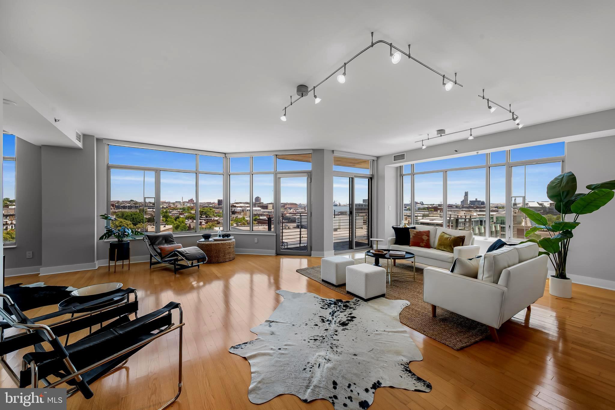 This stunning ensuite 2 Bedroom/ 2 Bath residence is prominently located in a contemporary 10 level building at the vertex of Fells Point, Harbor Point, and Harbor East. The condo boasts 1,781sq. ft. of premier, light-filled urban living space.  There are three privately covered balconies to enjoy the spectacular 270-degree views of the water and the city scape.  The dramatic open floor plan with floor to ceiling windows is flooded with natural light and 9’ ceilings.  Features and amenities of the home incorporate a delightful Foyer with conveniently located Powder Room, gourmet Kitchen equipped with gas cooking, wood cabinets, stainless steel appliances and granite countertops, multiple walk-in closets with California Closet custom buildouts, large Laundry/Utility Room, and a terrific primary spa-like Bath with free-standing soaking tub, spacious open shower with rain head, and floating double vanity with soapstone counter.  Enhancements include gleaming hardwood flooring throughout, custom window treatments, ceiling fans in the bedrooms, and recessed lighting.  Two adjacent garage parking spaces #128 and #129 and a secure garage storage area (6’ X 4.5’) convey. The building has 24-7 staffing and security.  It is desirably located close to various neighborhoods, restaurants, shopping, bars, coffee shops, hotels, Whole Foods, the Harbor promenade, the Inner Harbor, major highways, the Johns Hopkins and U of M Medical campuses, train stations, the stadiums, and cultural events.