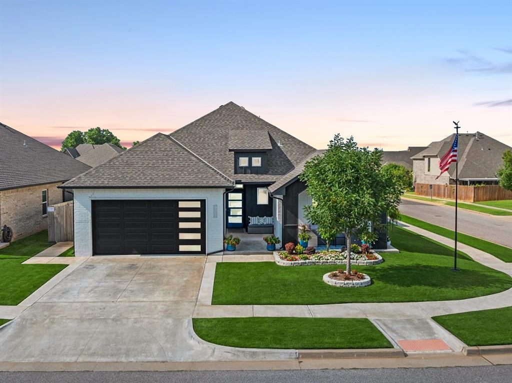 Welcome to Deer Creek Park—one of Deer Creek’s most sought-after communities, where thoughtful design meets everyday comfort. This beautifully crafted home features an open-concept layout with seamless flow between living, dining, and kitchen spaces, all enhanced by abundant natural light and stylish wood-look tile flooring throughout the main areas. The spacious kitchen is designed to impress with gleaming countertops, tile backsplash, walk-in pantry, gas range, and a center island with counter seating—perfect for gathering with family and friends. The large great room offers versatile furniture arrangements, anchored by a cozy corner fireplace and surrounded by oversized windows that bring the outdoors in. The private owner’s suite is a relaxing retreat, showcasing a spa-like bath with a freestanding soaking tub, double vanities, and a massive walk-in closet. Every corner of this home reflects quality finishes, modern design, and attention to detail. Enjoy evenings under the covered back patio or take advantage of the community amenities, including a neighborhood pool and playground. With its open, light-filled layout and contemporary style, this home offers the perfect blend of comfort and livability.  Additional features:  Inground storm shelter in the garage; Surround sound speakers in main living and primary suite; Epoxy garage floors; Custom shades and drapes.  Located in the sought-after Deer Creek neighborhood and zoned for top-rated Deer Creek Schools, this home blends lifestyle, location, and comfort into one incredible opportunity. Welcome Home!