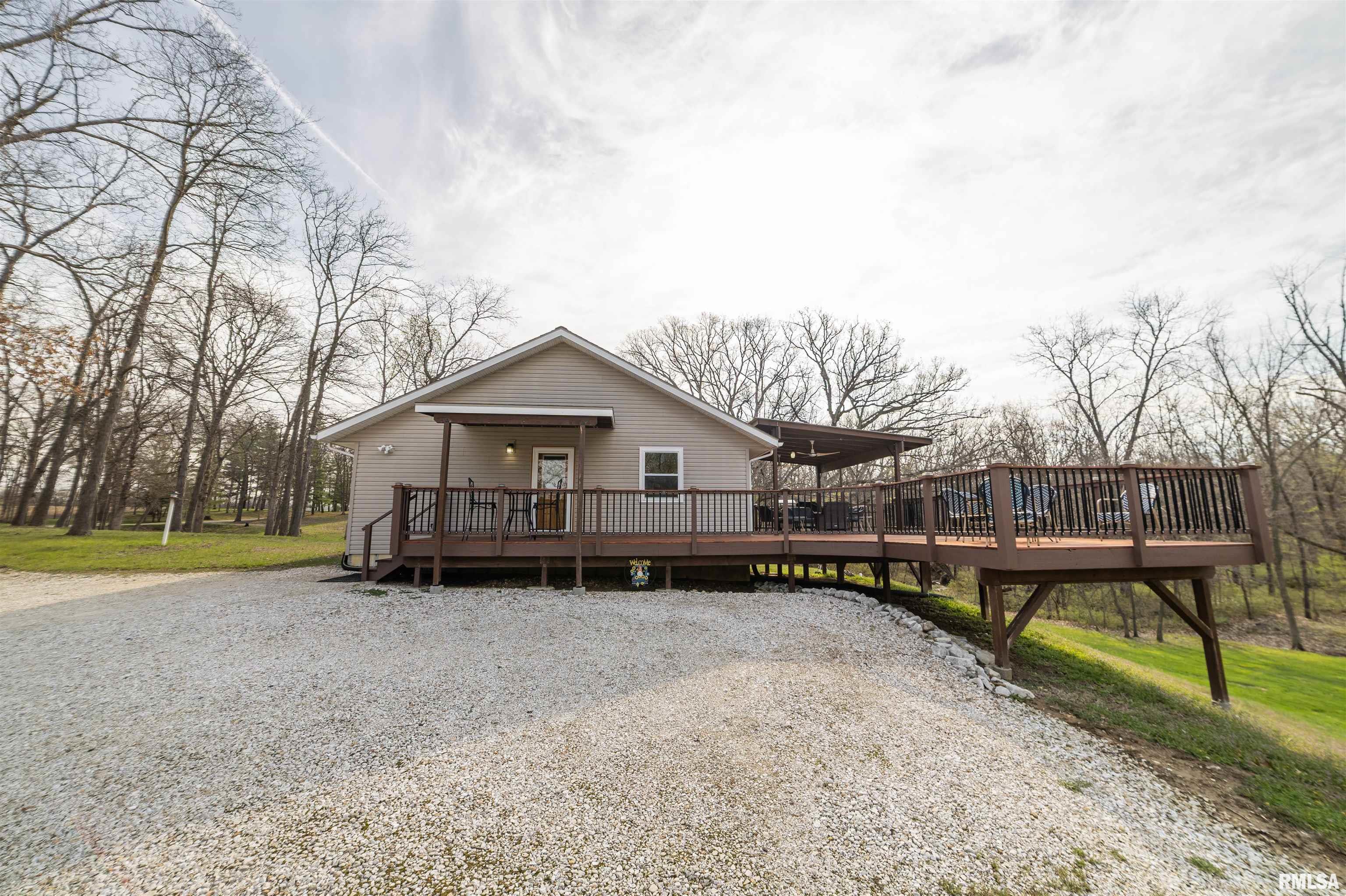 One-owner, meticulously maintained home situated on 12.34 wooded acres with ATV trails throughout. This 3 bed, 2 bath all electric home features vaulted ceilings and open concept floor plan with gorgeous custom cabinetry throughout. Spacious living areas offer excellent flow for everyday living and entertaining. Fully finished walk-up basement provides additional living space and versatility. Exterior highlights include an oversized deck overlooking the private, wooded setting. Property also includes two machine sheds (36x72 & 24x48), providing ample storage for equipment, vehicles, or hobbies. Ideal for buyers seeking acreage, privacy, and a well-cared-for home with functional outbuildings. Geothermal (2012), Water softener (2016), water heater (2023), Replacement windows (2016), Deck refinished (2025), Deck boards replaced (2020)