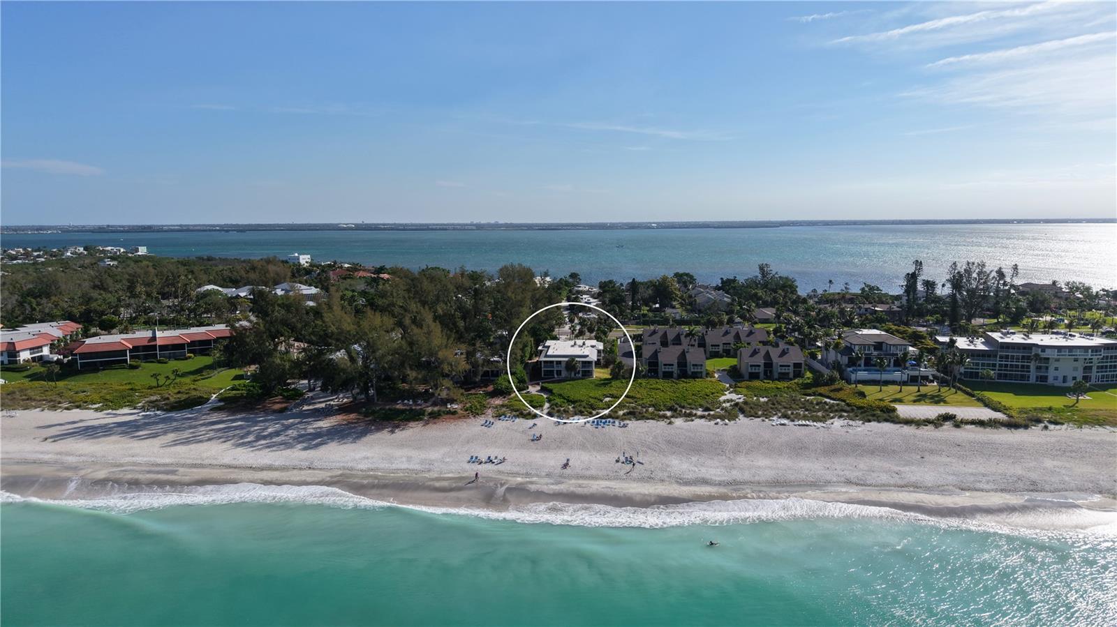 Turnkey furnished and positioned just steps from the Gulf’s sandy shoreline, this first-floor residence at Beach Castle on Longboat Key offers a compelling combination of coastal living and proven rental potential. With flexible daily or weekly rental allowances, this two-bedroom retreat presents an exceptional opportunity for personal use, income generation, or both. The light-filled interior features an open layout designed for ease and comfort, where the kitchen, dining, and living areas flow together naturally. Oversized tile flooring, updated impact glass, and sliding doors enhance both durability and livability, while the kitchen is well-appointed with granite countertops, solid wood cabinetry, stainless steel appliances, and built-in shelving—creating a functional space for everyday living or hosting. Floor-to-ceiling sliders lead to a private patio and screened lanai, offering a seamless transition to the outdoors and placing you just moments from the beach. The split-bedroom plan provides added privacy, with the primary suite enjoying direct access to the outdoor space, while the guest bedroom is comfortably sized with its own en-suite bath.Set within the boutique Beach Castle community, residents enjoy a unique beach-to-bay lifestyle with deeded Gulf access, a heated swimming pool and spa, grilling areas, and a fishing pier with day dock on Sarasota Bay. Lush landscaping and well-maintained grounds create a relaxed, resort-style setting that enhances both owner enjoyment and guest appeal. Located on the desirable north end of Longboat Key, this property is just minutes from Bayfront Park, Cedars Tennis Resort, and the island’s scenic biking and walking paths. A short drive south brings you to the Longboat Key Club, St. Armands Circle’s dining and boutiques, and downtown Sarasota’s renowned cultural venues, waterfront parks, and year-round events.With strong rental history, immediate beach access, and a turnkey presentation, this Beach Castle residence offers a rare opportunity to enjoy the best of Longboat Key—whether as an investment, a private getaway, or a combination of both.