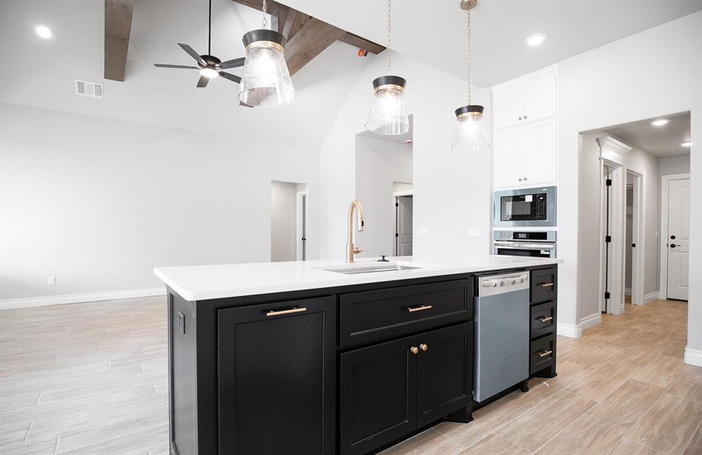 This Blue Spruce Bonus Room 1 floor plan includes 2,640 Sqft of total living space, which features 2,350 Sqft of indoor living and 290 Sqft of outdoor living space. There is also a 590 Sqft, three car garage with an in-ground storm shelter installed. This home offers 4 bedrooms, 3 full baths, 2 covered patios, a large bonus room, and a utility room. The great room welcomes a pristine cathedral ceiling with a crows feet detail, a ceiling fan, excellent wood-look tile, rocker switches throughout, Cat6 wiring, and large windows. The kitchen supports stainless steel appliances, a 5-burner cooktop, 3 CM countertops, a center island with a trash can pullout installed, well-crafted cabinets to the ceiling with under cabinet lighting and cabinet hardware installed throughout, exceptional pendant lighting, and a separate walk-in pantry. The primary suite features a sloped ceiling with a ceiling fan, windows, and our cozy carpet finish. The attached primary bath hosts separate vanities with framed mirrors, a European walk-in shower, a free-standing tub, a private water closet, and a HUGE walk-in closet. Outdoor living has a wood-burning fireplace, a gas line, and a TV hookup. Other amenities include our healthy home technology, a tankless water heater, a whole home air filtration system, R-44 insulation, and so much more!