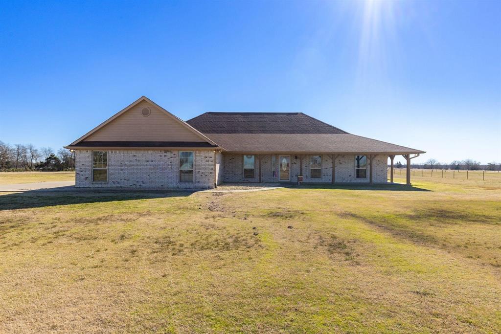Sit on the wraparound front porch and enjoy the country views at the end of a long driveway on 6.216 acres! This 4 bedroom, 2.5 bath brick home, with over 3,000 square feet, comes with 2 living areas, 2 dining areas, and a game room. Step inside through a foyer hall where the formal dining is off to the left or easily use the room as office space. A wall of windows floods light into the main living room that is attached to a breakfast area with a door that gives you access to the covered back patio. The kitchen includes an island, double ovens, breakfast bar, cooktop, and walk-in pantry. A family room is located next to an extra large game room! Or you can close off the game room to make a 5th bedroom or convert the family room and game room into a mother-in-law suite. In addition, you also have three guest bedrooms which are split from the primary ensuite. Relax in the spacious primary bedroom which has an abundance of windows, a jetted soaking tub, separate shower, separate vanities, and a walk-in closet. Other items are a 2-car garage, recessed lights, and crown molding. If you need more land, additional acreage is availabl (for a total of 41 acres). With a great floor plan layout and additional land available, you can create the dream property you've always wanted!
