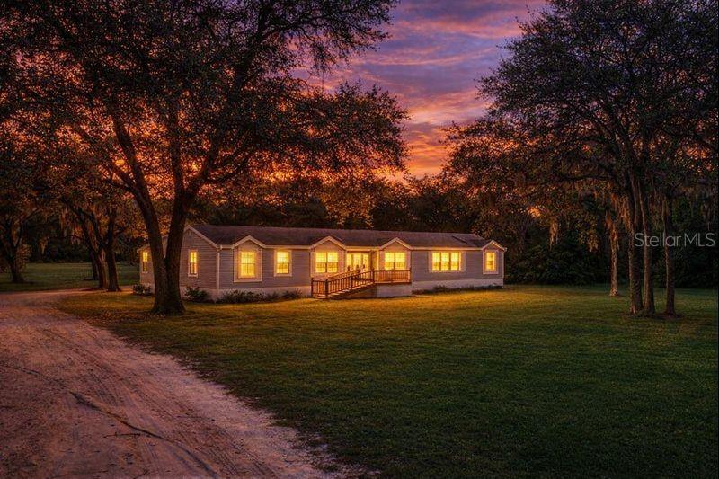 One or more photo(s) has been virtually staged. Spacious 4-Bedroom Manufactured Home on 1.5 Acres with Resort-Style Outdoor Living!Welcome home to this beautifully maintained 2004 manufactured home situated on 1.5 fully usable acres, offering privacy, space, andexceptional outdoor amenities. A welcoming wood front porch with ramp access sets the tone for easy living.Step out back to your own private oasis featuring a heated above-ground pool and a Max Collection 8-person jacuzzi with lighting andBluetooth, all surrounded by a full wood deck—perfect for entertaining or relaxing year-round.This property has been thoughtfully updated with major improvements, including a new well pump (2020), new septic system and drain field(2021), new A/C (September 2025), water softener, new ceiling fans, and fresh interior paint. The home is fully fenced with wood fencing,enhanced by motion-activated flood lights throughout the property.Ideal for those seeking a mini-farm or hobby homestead, the land includes an enclosed area for farm animals, two small sheds, and one largeshed for storage, tools, or equipment.Inside, the home offers a 4-bedroom, 2-bath split floor plan with vinyl plank flooring throughout. The spacious primary suite includes awalk-in closet and private en-suite bath. Enjoy a large laundry room, generous kitchen, and multiple living spaces including a living room,dining area, and family room, providing flexibility for everyday living and gatherings.This unique property blends comfort, functionality, and outdoor enjoyment—schedule your private showing today