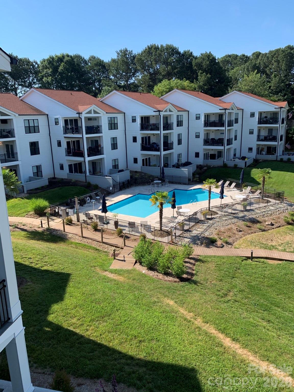 Perched on the third floor in the highly desirable Half Moon Bay community, this inviting condo offers beautiful views of Lake Norman and a relaxed, low-maintenance lifestyle in the heart of Cornelius. Enjoy peaceful mornings and stunning sunsets from your private vantage point overlooking the water.Inside, the open-concept layout is filled with natural light, creating a bright and airy feel throughout the main living space. The living room flows seamlessly into the dining area and kitchen, making it ideal for both everyday living and entertaining. Large windows and sliding glass doors showcase the lake views and bring the outdoors in.The spacious primary suite provides a comfortable retreat, while an additional bedroom offers flexibility for guests, a home office, or hobbies. Thoughtful design and easy flow make the home both functional and welcoming.Seller is offering 'Buyer Choice' credit at closing with acceptable offer that the buyer may use toward, home improvements.  Located just minutes from shopping, dining, and marina access, this condo combines convenience with scenic charm. Whether you're looking for a full-time residence, weekend getaway, or investment opportunity, this Lake Norman-view property delivers the best of lakeside living.