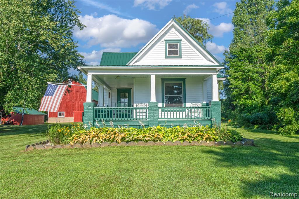 Welcome to 915 N. Van Dyke in Imlay City—a peaceful country escape nestled on 5.5 private acres with a pond and shared access to a picturesque 14-acre lake. Perfect for outdoor enthusiasts, the lake is fully stocked with a wide variety of fish, including largemouth and smallmouth bass, blue channel catfish, perch, crappie, sunfish, bluegill, walleye, and northern pike.  Whether you're casting a line, kayaking at sunset, or simply enjoying the view, this property offers year-round enjoyment.  A welcoming wraparound porch sets the tone for relaxed country living in this charming 3-bedroom, 1.5-bath home.  Inside, you’ll find a spacious den—ideal for a second living area or home office—and an open layout that flows seamlessly from the living room to the kitchen.  Modern updates throughout include all-new windows, a metal roof, updated HVAC, electrical, and plumbing systems, plus a new water softener.  The kitchen is both stylish and functional, featuring white cabinetry, sleek butcher block countertops, and new stainless steel appliances.  Outdoors, you’ll find a 30x40 Barn along with an additional Shanty-style building featuring a durable metal roof.  Whether you need extra storage, space for hobbies, or the ultimate man cave retreat, these versatile outbuildings offer endless possibilities.  With a blend of rustic charm and thoughtful upgrades, this property offers the perfect balance of comfort, character and adventure.  Schedule your showing today!!