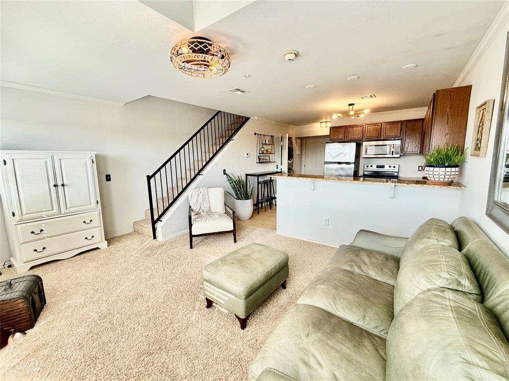 Just one mile from the OU campus, this inviting East Village condo offers a bright, open-concept kitchen and living area on the main level, along with a convenient half bath and a full-size stackable washer and dryer. Upstairs, the spacious bedroom features a large walk-in closet and a private full bathroom. Residents enjoy access to community amenities including a 24/7 fitness center and a clubhouse complete with a TV lounge, pool table, and kitchenette—perfect for relaxing or entertaining.