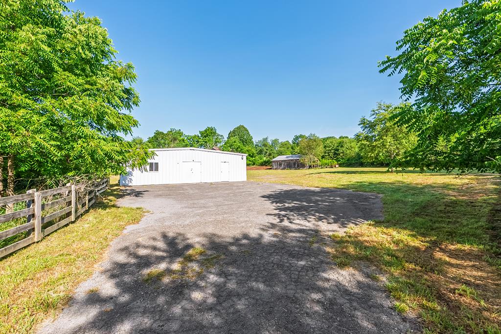 Great property with loads of potential close to I-77 in Bland, VA. This steel building structure has a total of approx. 2600 sq ft with approx. 1000 sq ft of it that has been finished at one time for residential use. There are two bedrooms, two half baths that could be combined to one large bath if desired, a large kitchen and more.  Currently the building is in need of TLC to get it back up to par but there is already a well and septic in place as well as an outbuilding and shed.  There is no working heating or cooling at this time, or a water heater, so again TLC will be needed, but this is a good opportunity for someone with their own local business.  Paved parking area with plenty of room and approx. 3 acres of land. Plat on file. Property being sold as is.