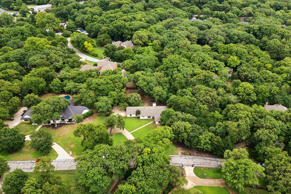 This heavily wooded 1-acre lot with mature trees offers the perfect blend of serenity and comfort in the prestigious River Oaks community. Though this lot currently has a beautiful and livable home, the neighborhood affords to reconstruct with a large custom home, a sizable pool, and with room for other entertaining opportunities; outdoor living, sport court, detached additional garages. This property has a 1,000-gal underground propane tank for a future pool. No HOA! Located within exemplary Lovejoy ISD, this prime location in a quiet neighborhood offers an exceptional living experience with easy access to amenities, shopping, dining, and major thoroughfares.