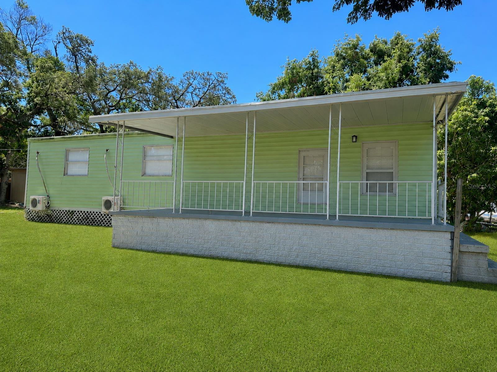 One or more photo(s) has been virtually staged. Welcome to your own slice of Florida living! This well-kept 3-bedroom, 1-bath double-wide mobile home offers comfort, flexibility, and exceptional outdoor entertaining on a private, fully fenced 12,375 sq. ft. lot with no HOA fees. With 1,152 sq. ft. of living space, this move-in-ready property combines affordability, functionality, and lifestyle.Inside, you’ll find laminate flooring throughout, a meticulous kitchen, and a comfortable layout ready for you to personalize and make your own. The spacious living areas create a warm and inviting atmosphere perfect for everyday living or hosting family and friends.Step outside and discover one of the property’s standout features — a beautifully upgraded outdoor entertaining space designed for true Florida living. The covered outdoor kitchen and lounge area includes a gas grill, sink, refrigerator, mounted TV, ceiling fans, LED lighting, and plenty of seating space, making it the perfect setting for barbecues, game days, and relaxing evenings under the lights.The expansive backyard offers endless possibilities with plenty of room for boat storage, pets, gardening, or simply enjoying the outdoors. A storage shed provides extra space for tools and belongings, while a mango tree and bird cage adds a tropical touch to the property. Conveniently located near schools, hospitals, libraries, shopping, restaurants, and supermarkets, and just minutes from vibrant downtown New Port Richey, where you can enjoy parks, festivals, waterfront dining, and year-round community events.Affordable, private, and move-in ready — homes like this don’t last long. Schedule your private showing today!