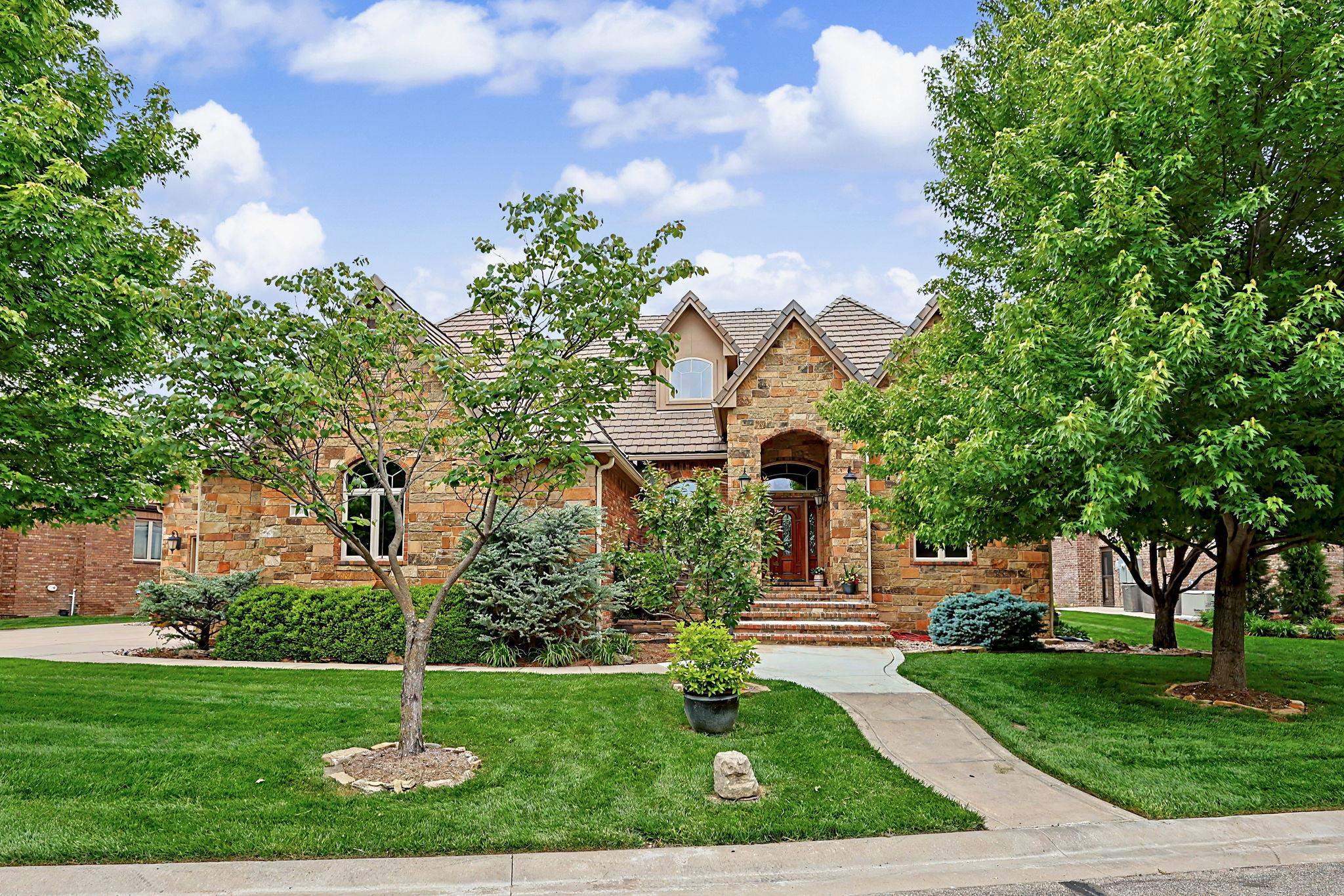 This beautiful one owner home features 5,400 SF of living area and is located on a secluded cul-de-sac in spectacular Flint Hills National. Wonderful craftsmanship and well planned storage space can be found throughout this gently lived in home. The open design provides great flow for entertaining guests or just relaxing with family. The main floor features a spacious living room with fireplace, vaulted ceilings and great views of the beautifully landscaped backyard, two large dining areas, a large kitchen with center island and walk-in pantry, a generously sized master suite with easy access to the covered deck, a second bedroom suite and beautiful office with a full wall of built-in bookshelves. The walkout basement includes a fantastic family room and game room area with fireplace and wet bar, two additional bedroom suites and an additional office. Outside you can enjoy the beauty and privacy of the incredibly well landscaped backyard and common area from either the covered deck or lower-level patio. The privacy of the property is enhanced even more by having common area directly across from the front of the home. Flint Hills National is a spectacular 640-acre private, gated retreat that wraps around the nationally recognized and Tom Fazio designed Flint Hills National Golf Club. Few places rival the beauty and artistic integrity of Flint Hills National Residences. Located in the award winning Andover school district.