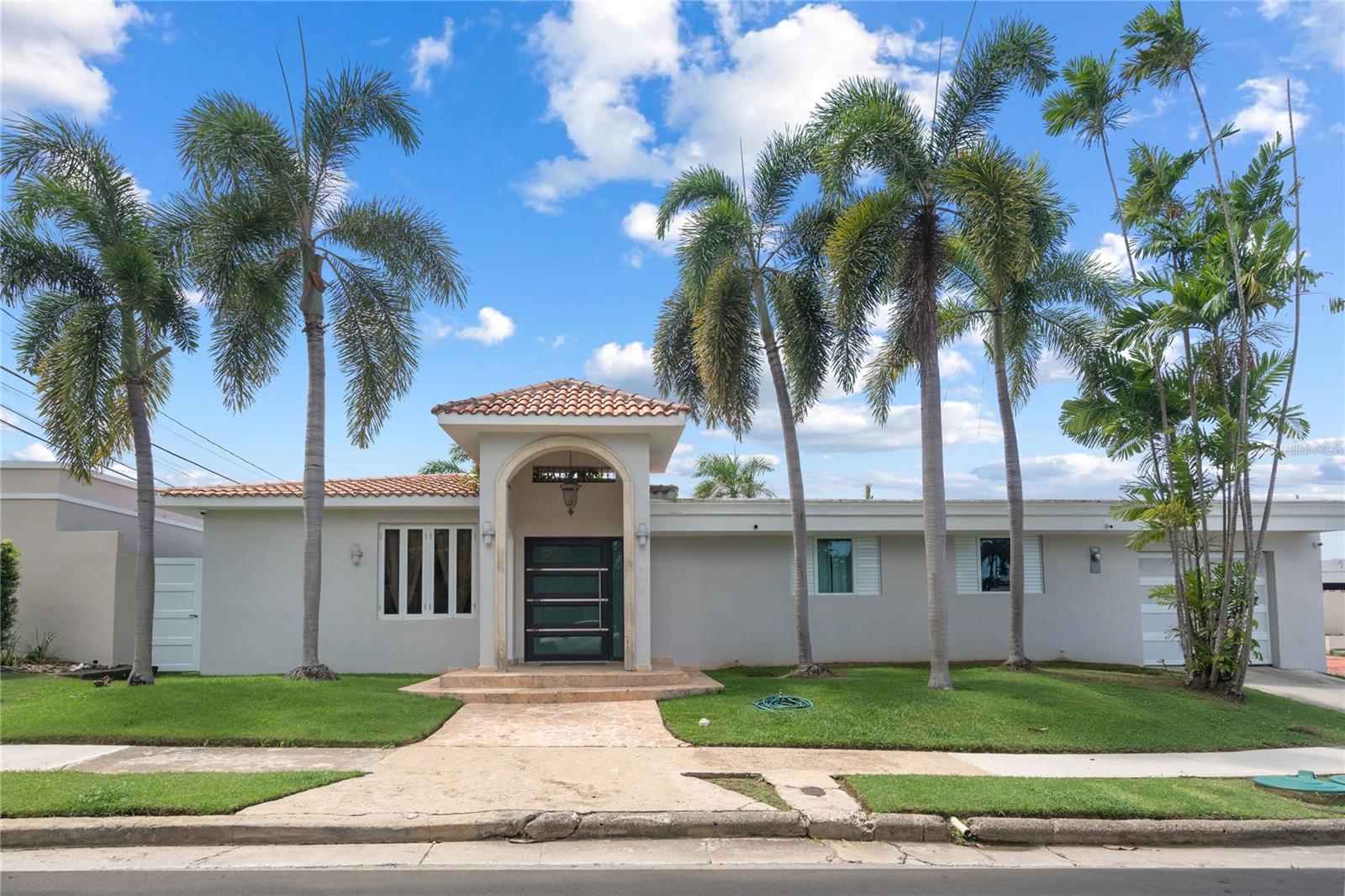 Single-story remodeled residence located at 840 Málaga Street in the gated community of Torrimar, Guaynabo. This 3,725-square-foot home features a layout of 4 bedrooms, 2.5 upgraded bathrooms, an extended remodeled kitchen, and two spacious family room areas. The exterior includes a private swimming pool, a heated jacuzzi, and 2 dedicated parking spaces. Situated on a high-demand street, the property offers 24/7 controlled security access and proximity to community parks and playgrounds.