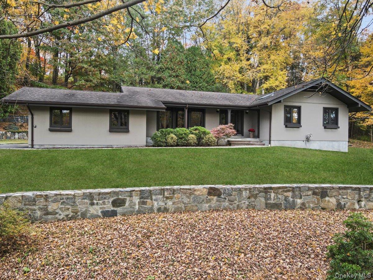 One level living in this meticulously updated and maintained no step 3 bedroom ranch home. The bright remodeled kitchen with large island, stainless appliances, abundant cabinets, and assess to deck is open to the great room with vaulted ceiling, wall of windows and wood burning stove. The living room flows into the dining room and gives you plenty of room to entertain. Down the hall, the primary suite has two closets and an ensuite bathrooms. There are two additional bedrooms and a modern hall bathroom. Lower level has a large recreation room, an office with a separate entrance, laundry room and plenty of storage. The outdoor spaces feature a private yard, an oversized wood deck and beautiful stone walls. Special details include a new furnace and hot water heater, radiant heat in kitchen, bathrooms and foyer, Marvin windows, two wood burning stoves, and an Ipe deck. Located in a quiet and convenient neighborhood that is close to town and the Armonk town pool.